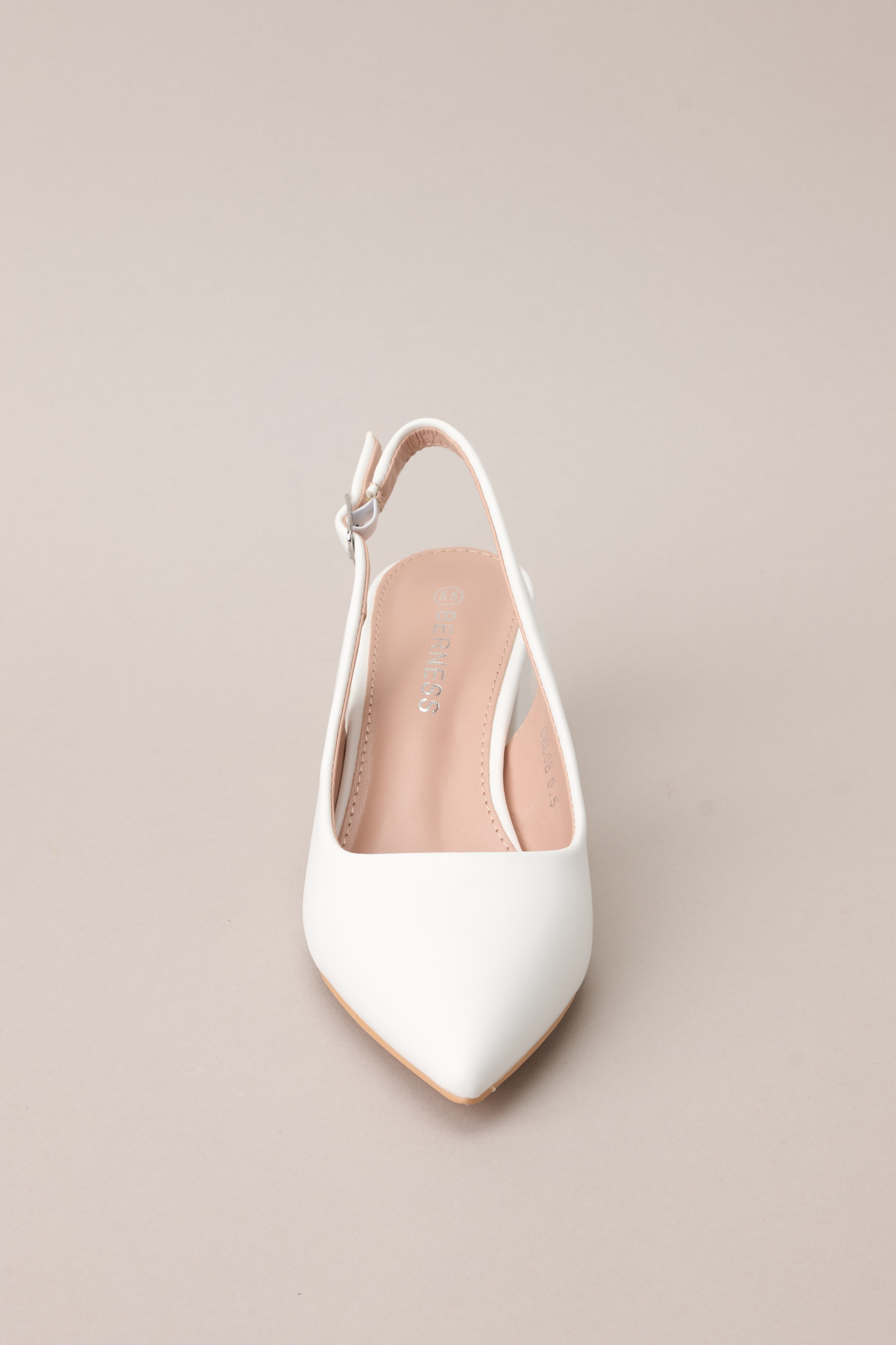 A direct front-facing perspective emphasizing the pointed toe shape and the structured design of the heels.