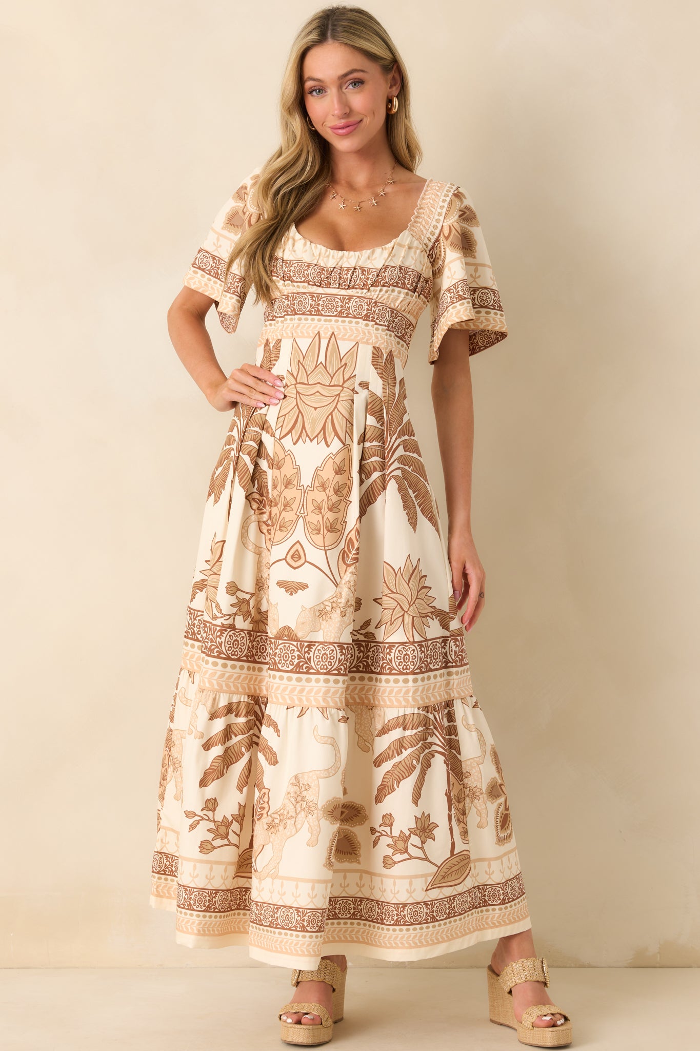 Full body view emphasizing the layered structure of the tiered skirt and the subtle print pattern throughout the beige fabric.