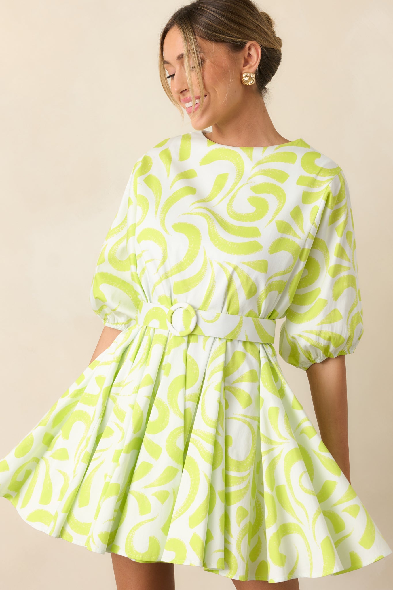 Mini dress with a lime green and white brush stroke print, round neckline, and fit-and-flare swing silhouette.