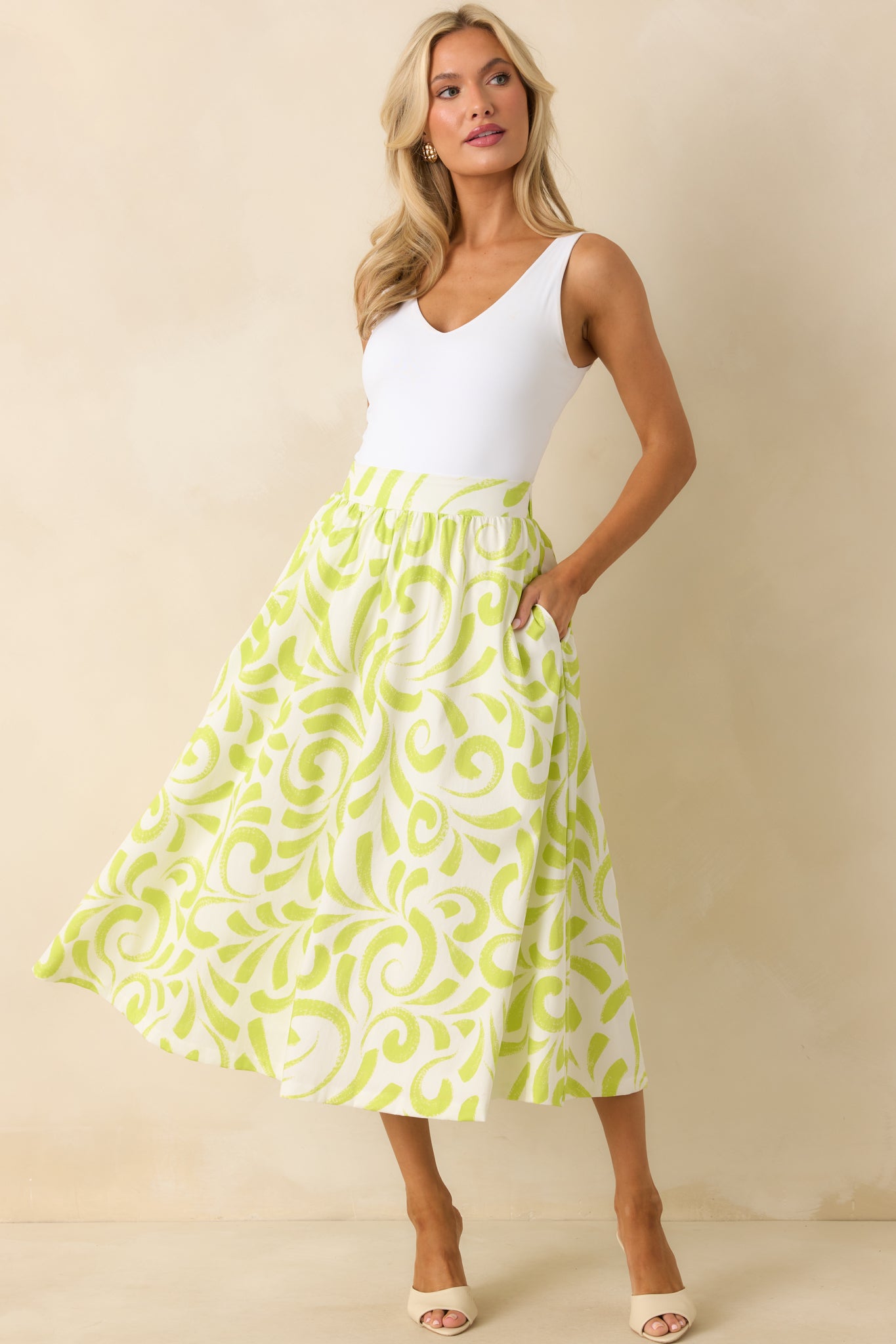 Midi skirt featuring bold brush stroke pattern, elastic back waistband, and practical pockets.