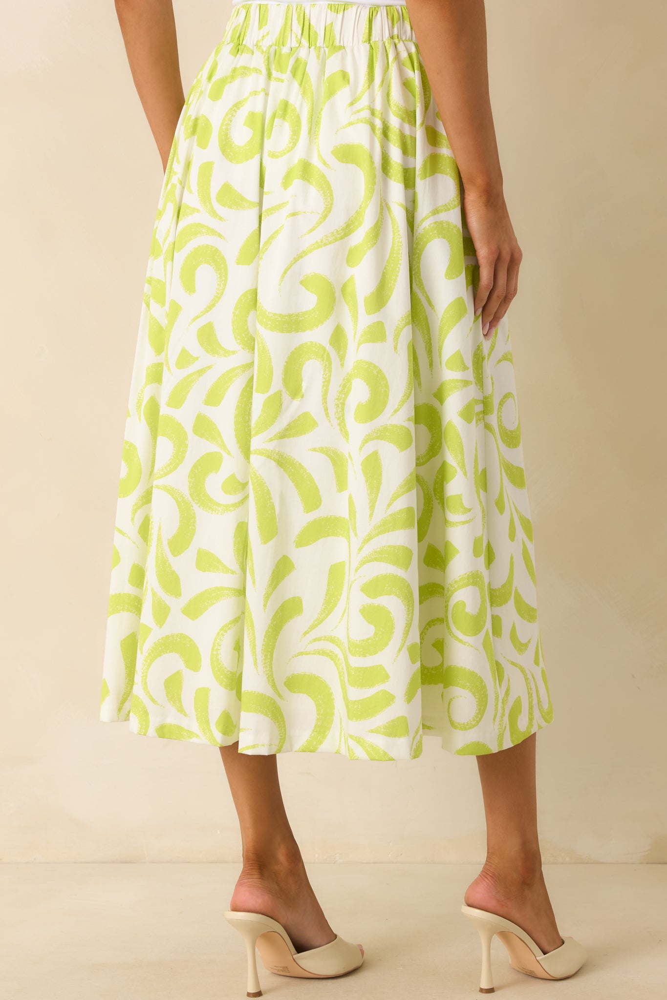 Rear view of the midi skirt with elastic waistband insert and continuous brush stroke print.