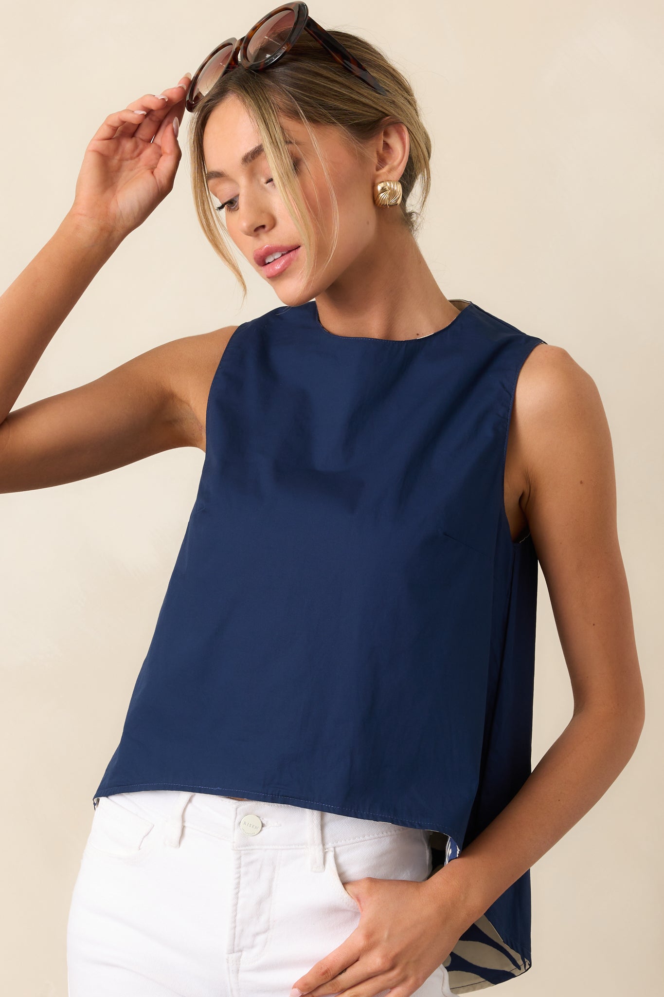 Close cropped shot of top highlighting mixed floral and solid navy fabric and scoop hem.