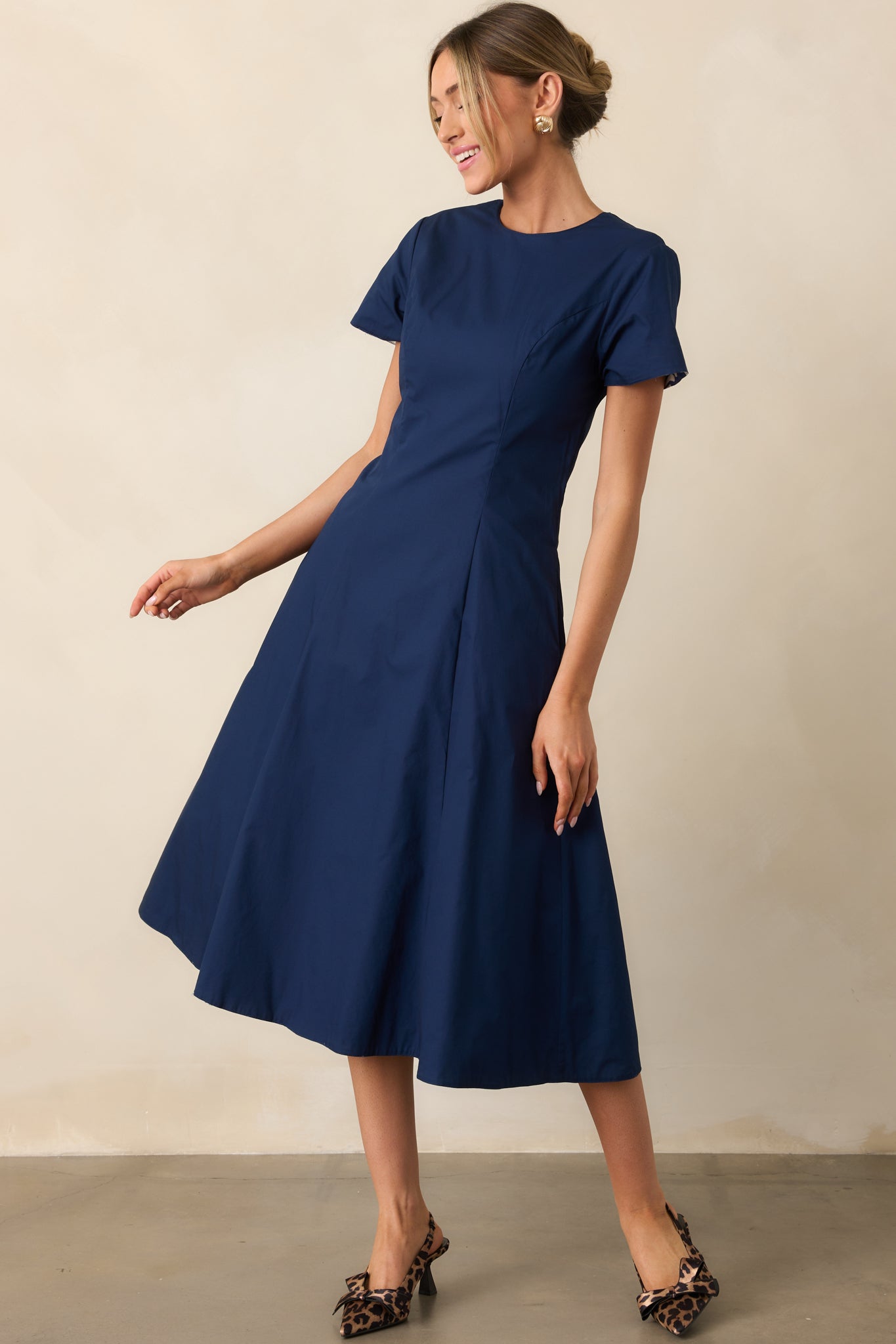 Full front-facing view of reversible midi dress highlighting functional pockets, fitted waist, and flowy skirt.