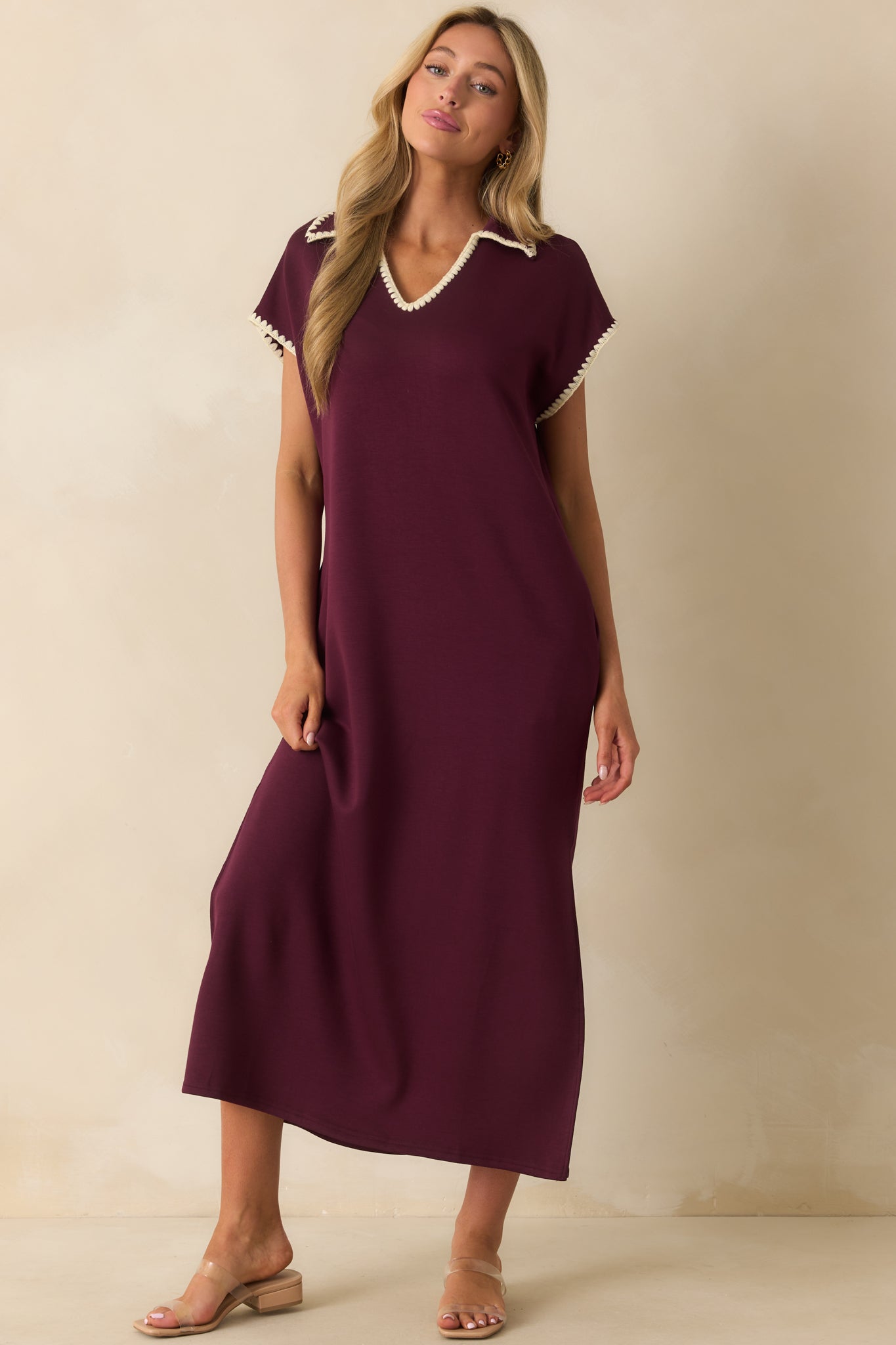 Purple maxi dress styled with ivory whipstitch trim and side slits at the hem.