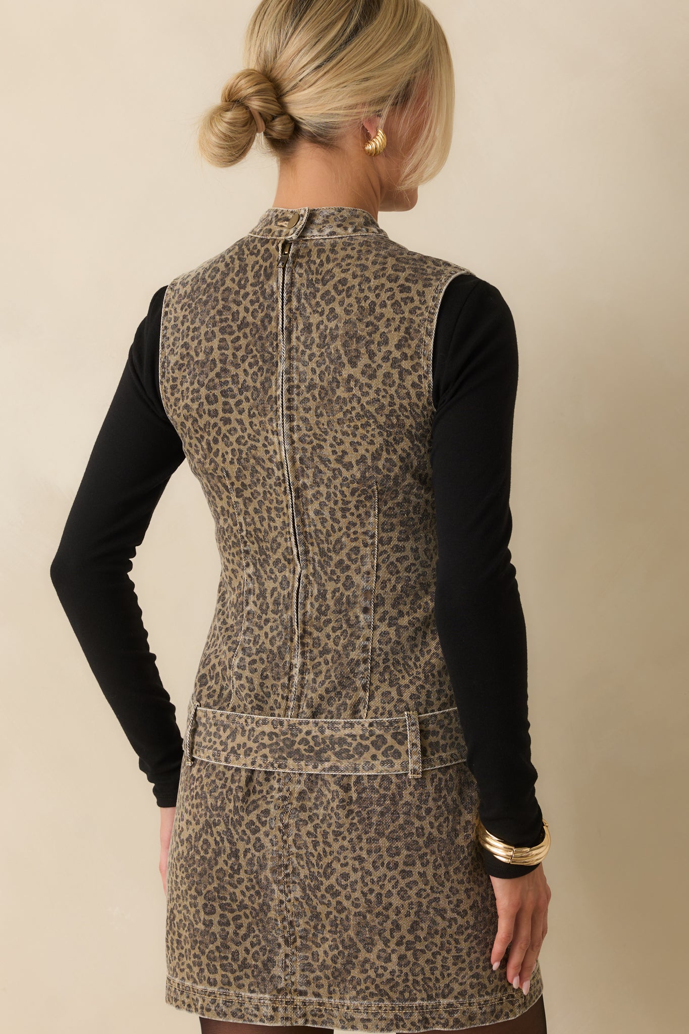 Rear view of the denim mini dress with hidden zipper and paneled design