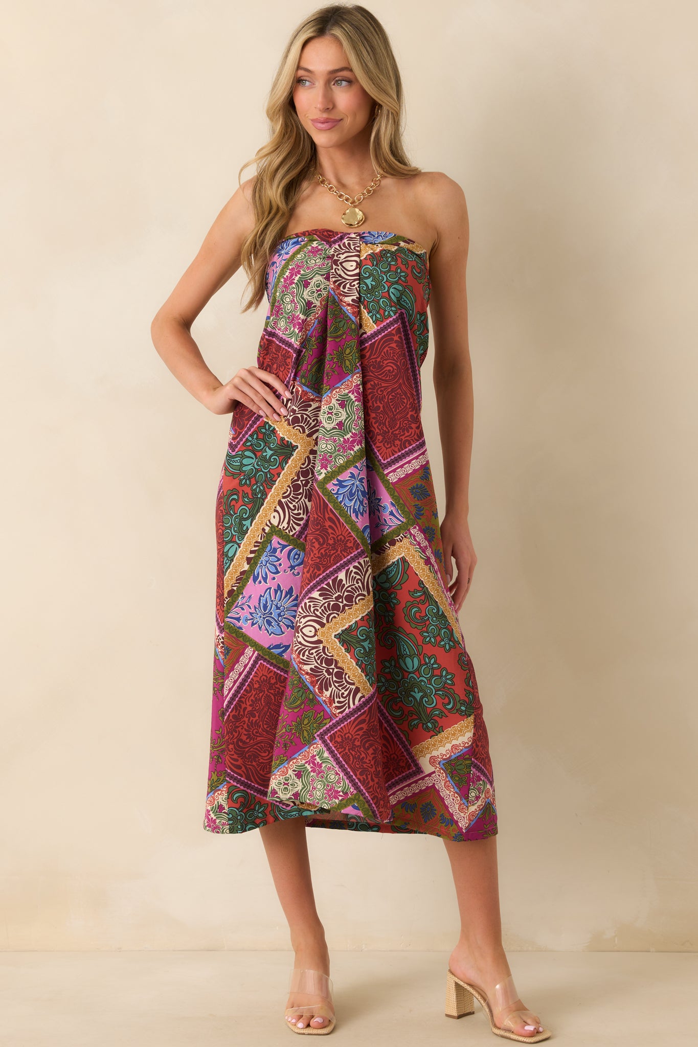 Red multi patchwork print midi dress showcasing a flowy fit and subtle front pleat detail.