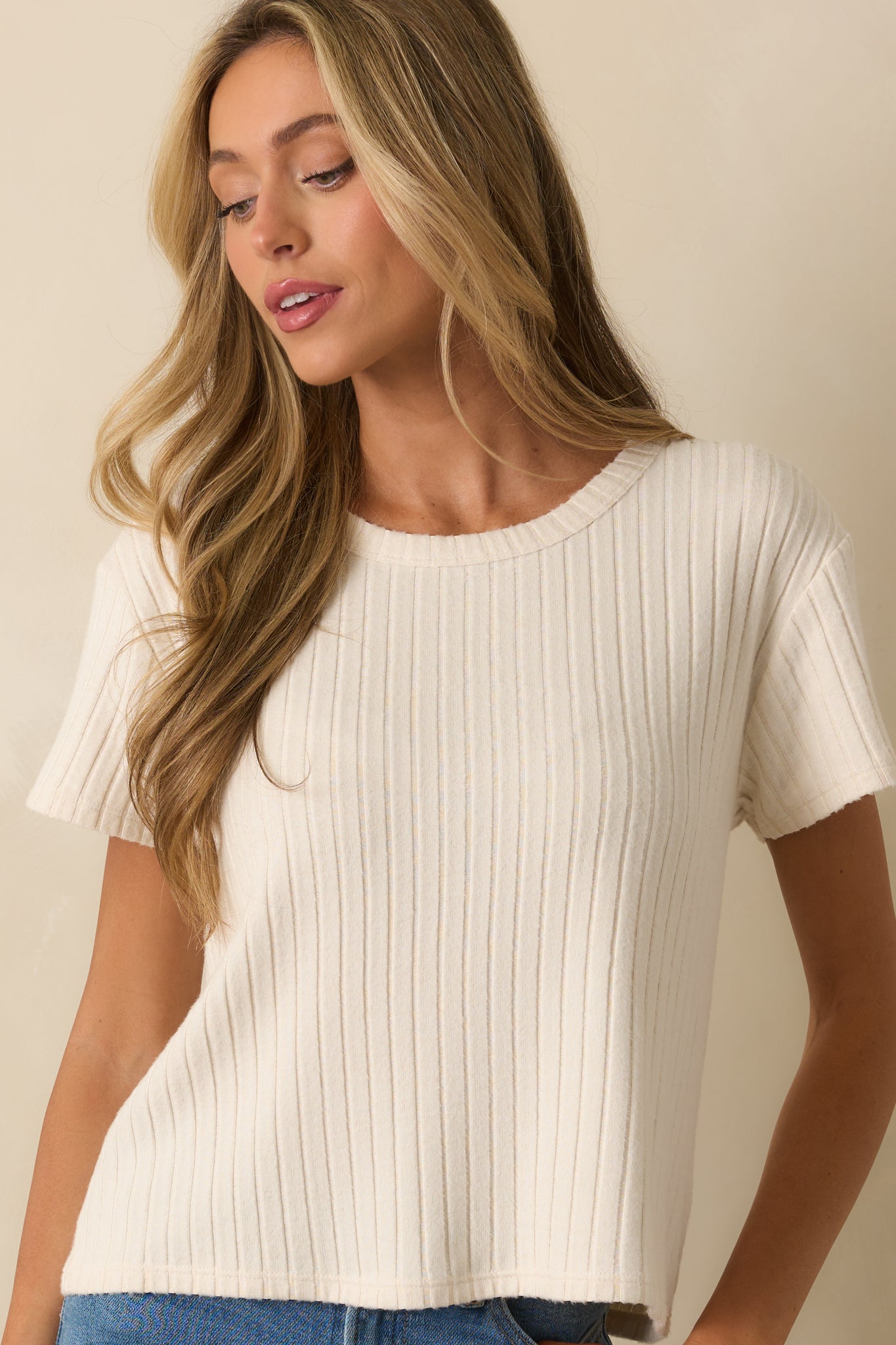Relaxed ivory tee with silky ribbed material and simple neckline detail.