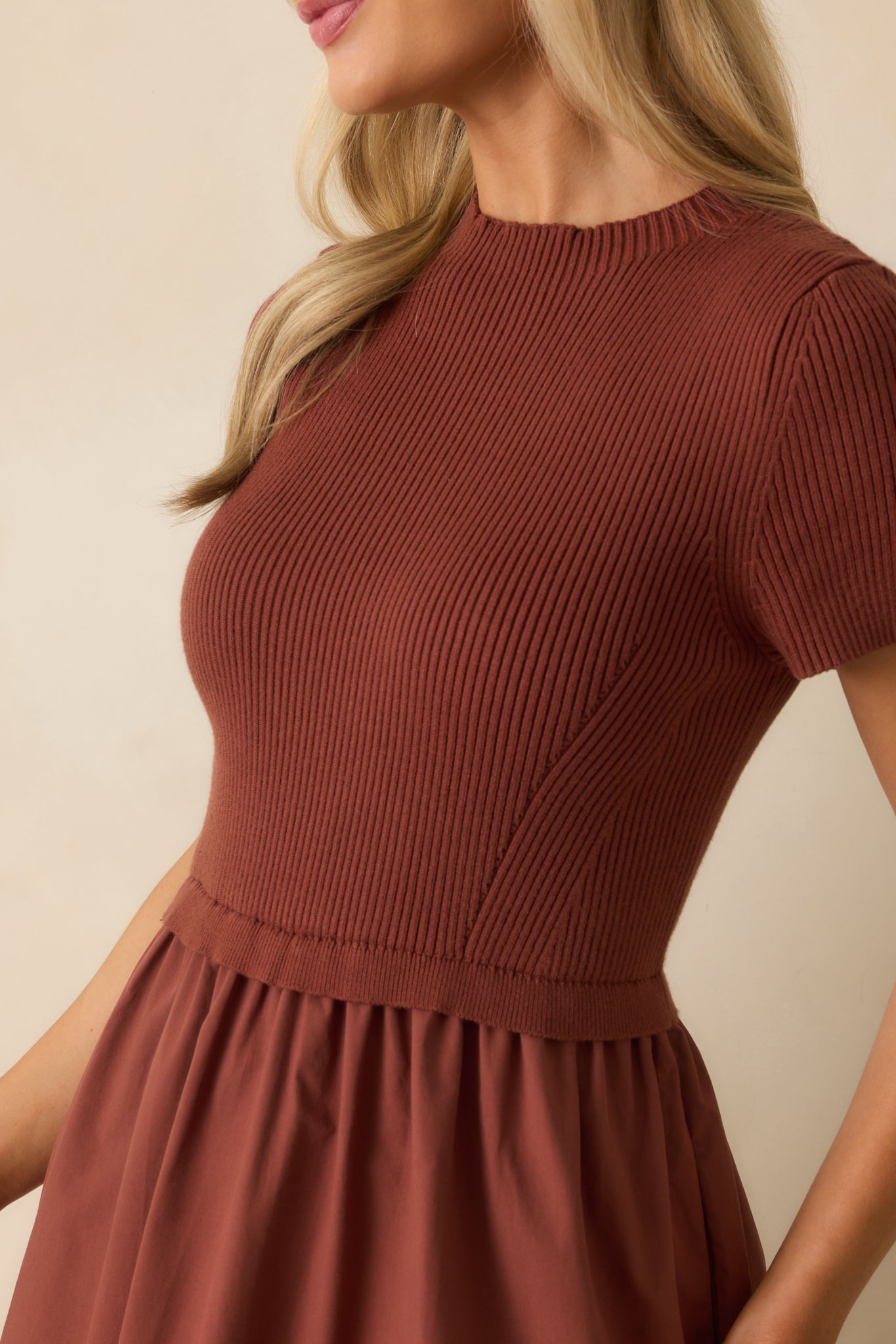 Close-up of the ribbed knit bodice, ruffle waist seam, and fabric contrast on the skirt.