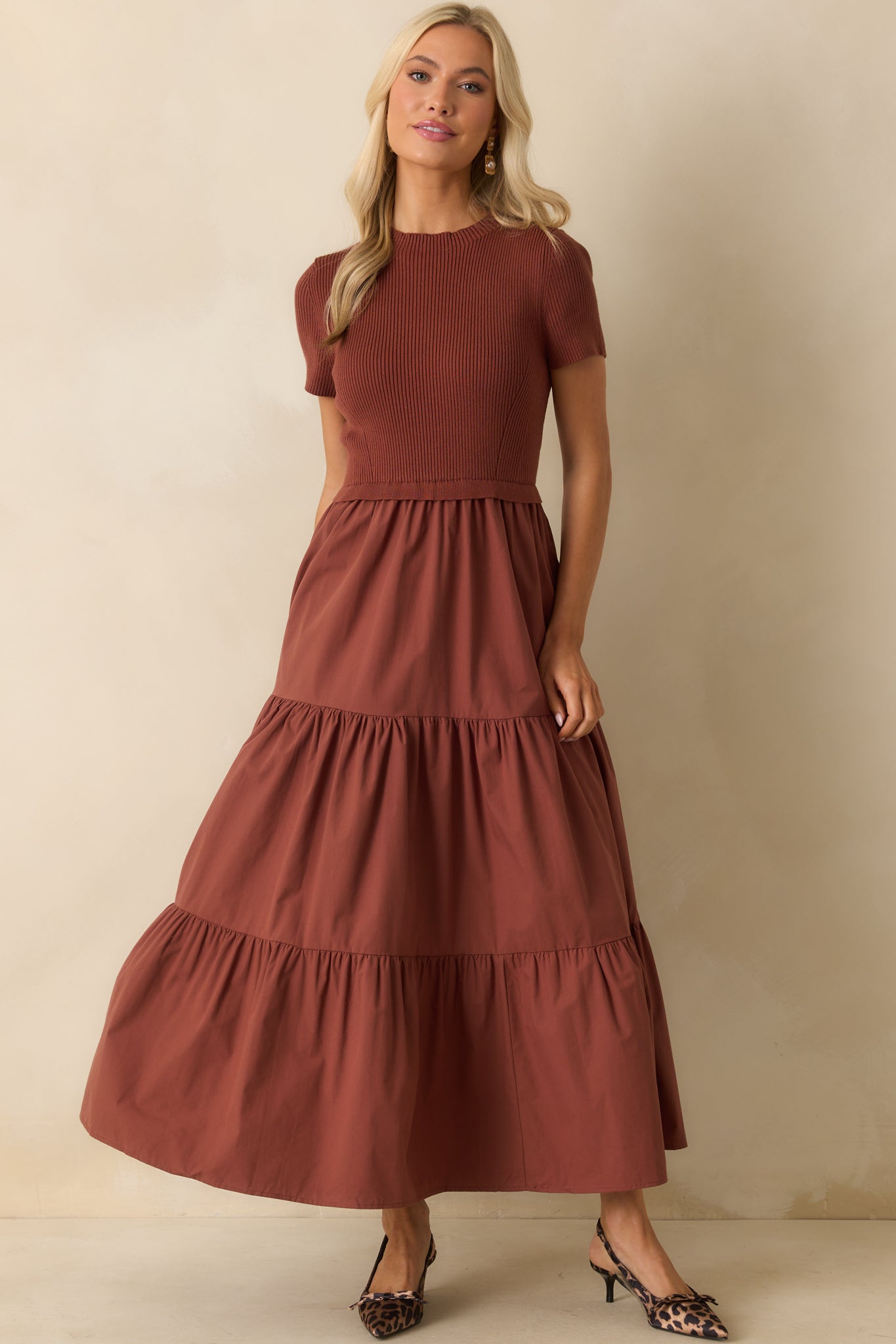 Rust maxi dress with a structured ruffle waist and relaxed A-line silhouette.