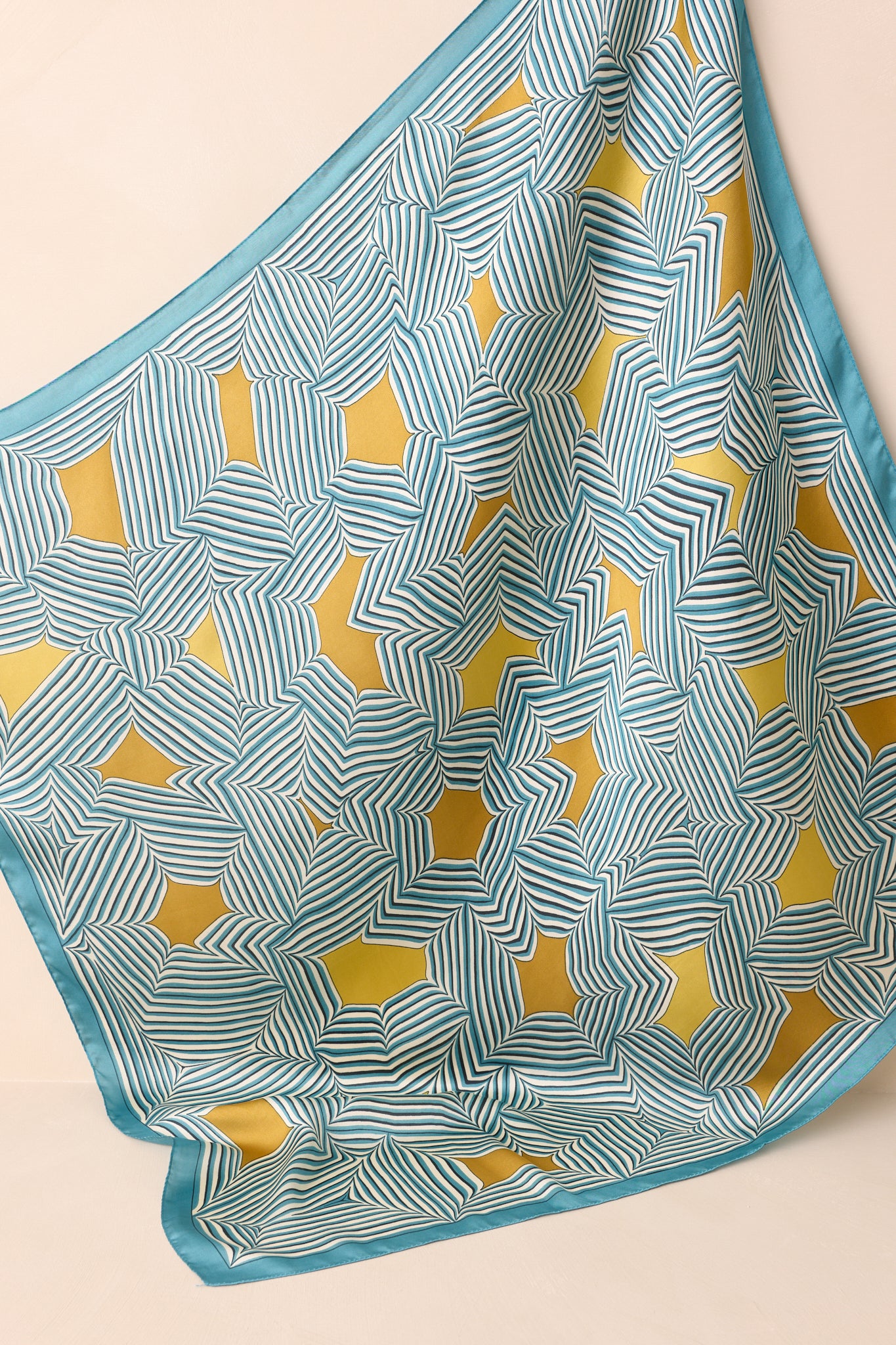 Entire scarf shown laid out, highlighting the smooth satin finish and bold mix of blue stripes with golden yellow details.