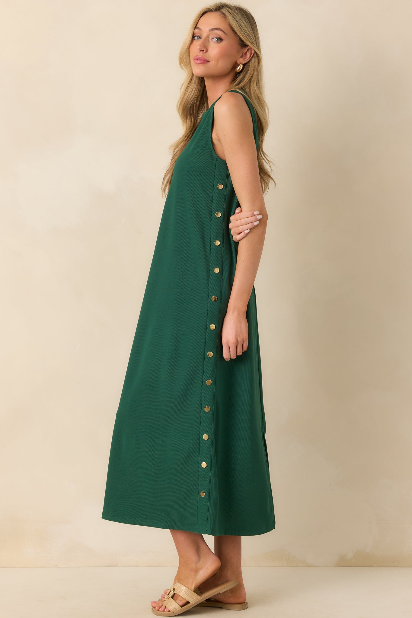 Full body side view of the dress, drawing attention to the long, straight silhouette and side button detail.