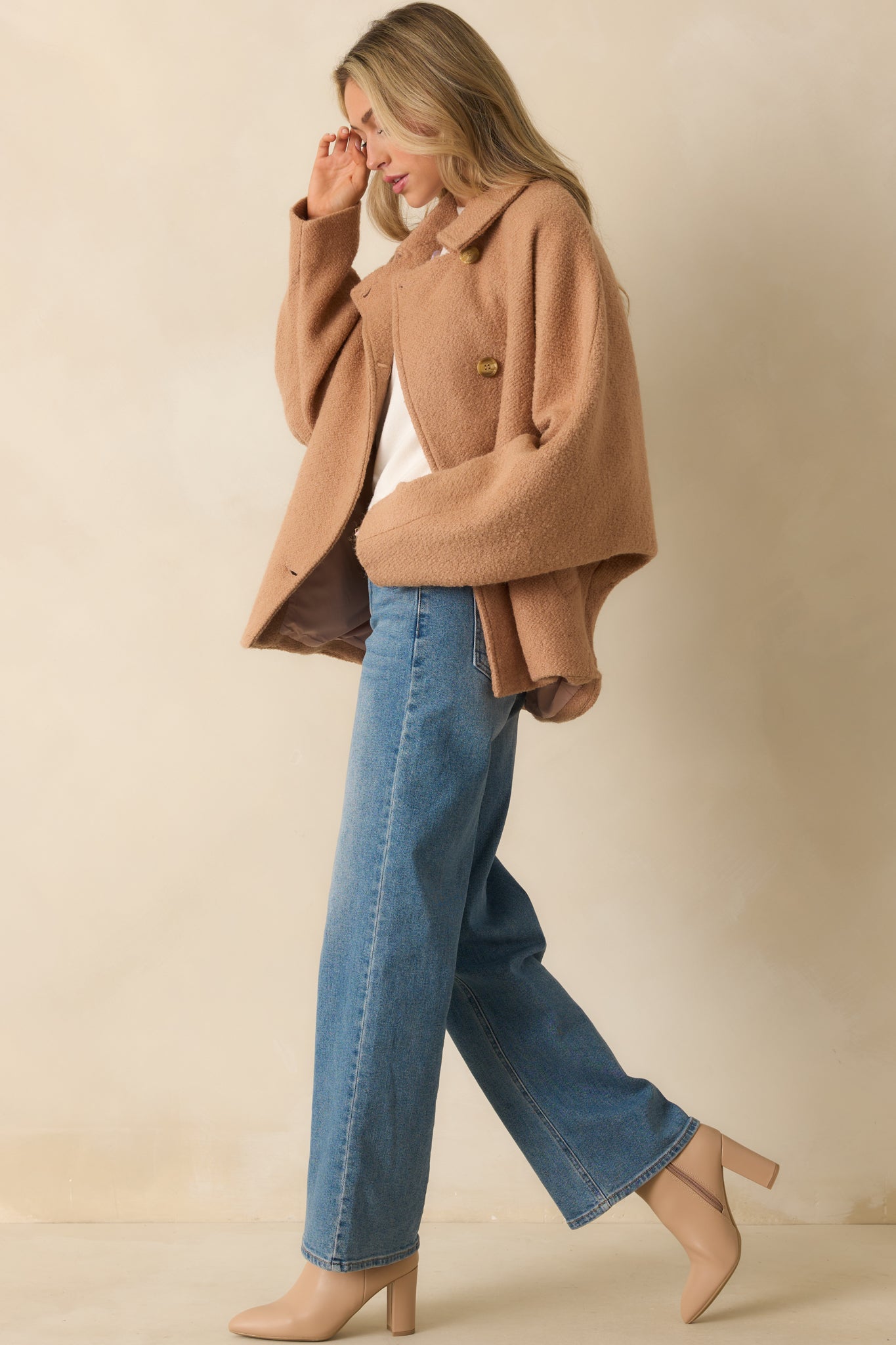 Side view of the camel brown coat showing the clean lines and straight hemline.