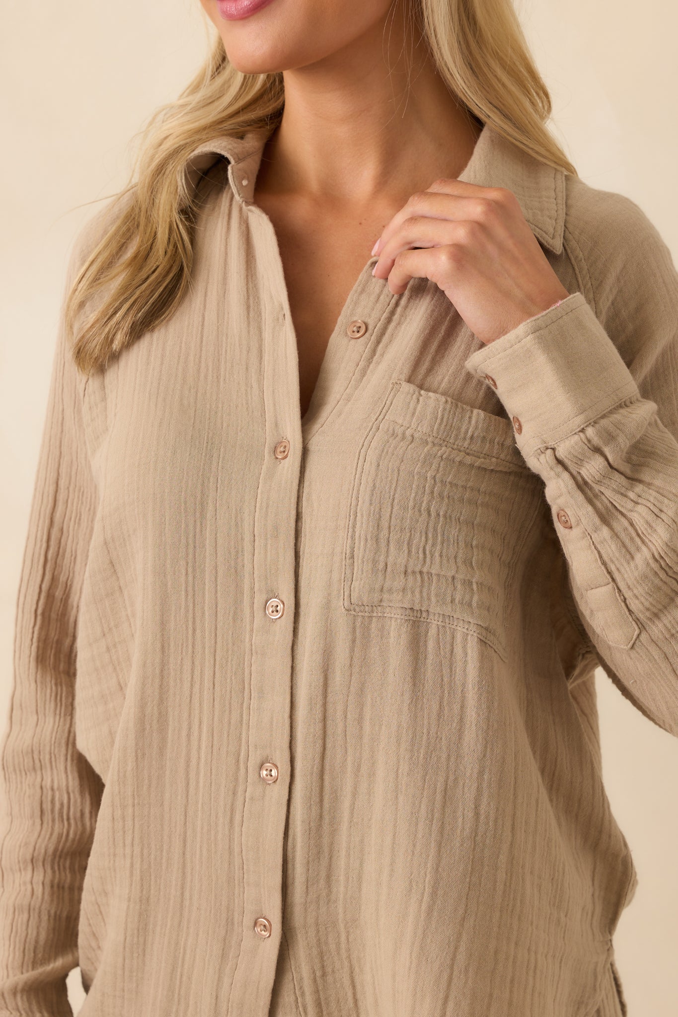 Close-up of the crinkle gauze fabric, showing stitching, fabric texture, and subtle structure around the front buttons.