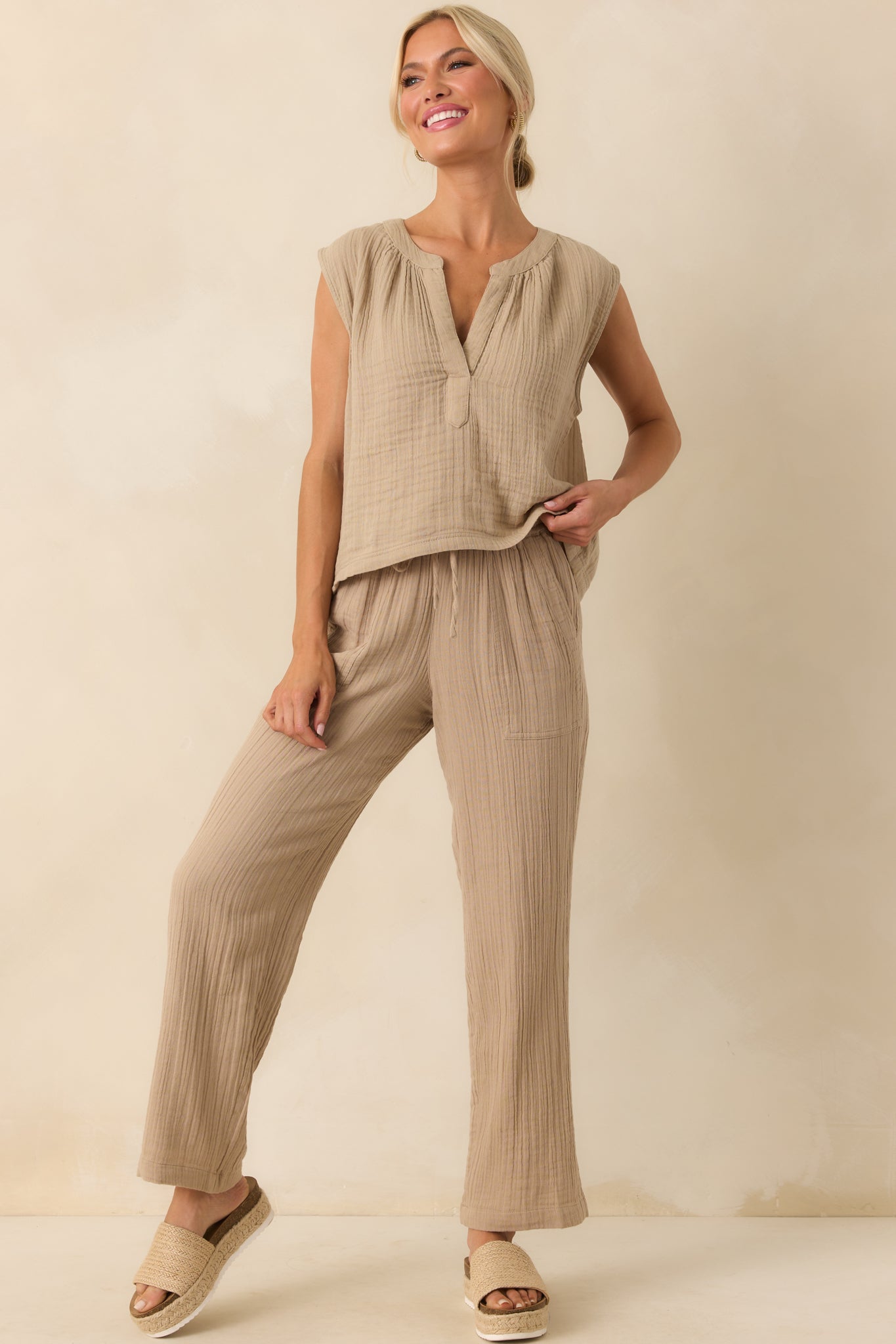 A front view of the tan pants showing the high rise fit and ankle length silhouette.