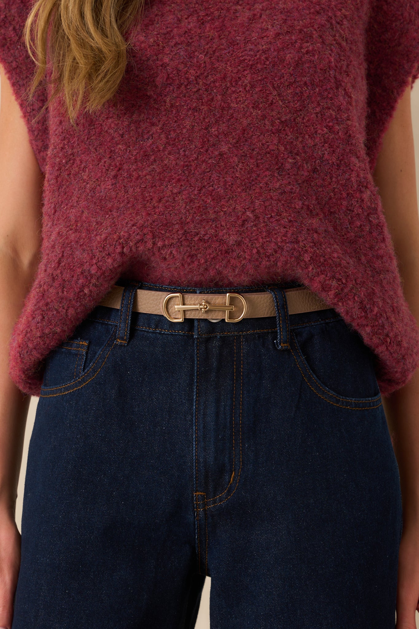 A close-up of the anchor buckle closure and gold hardware, emphasizing the textured surface of the faux leather.