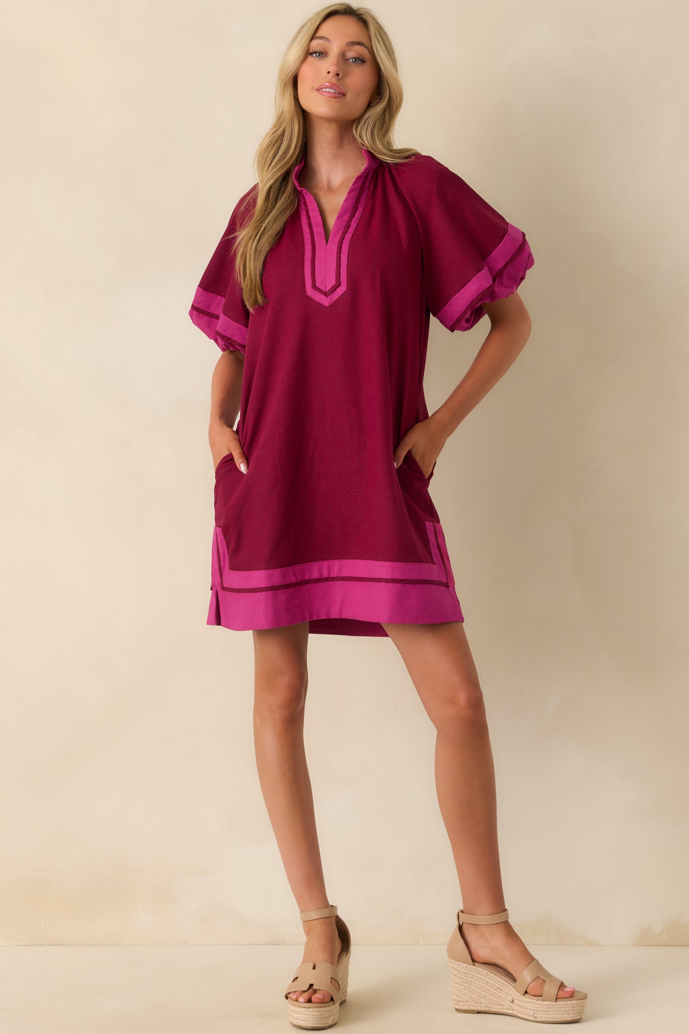 Full body image highlighting the pink contrast trim at the neckline and sleeves, along with the relaxed shape of the dress.