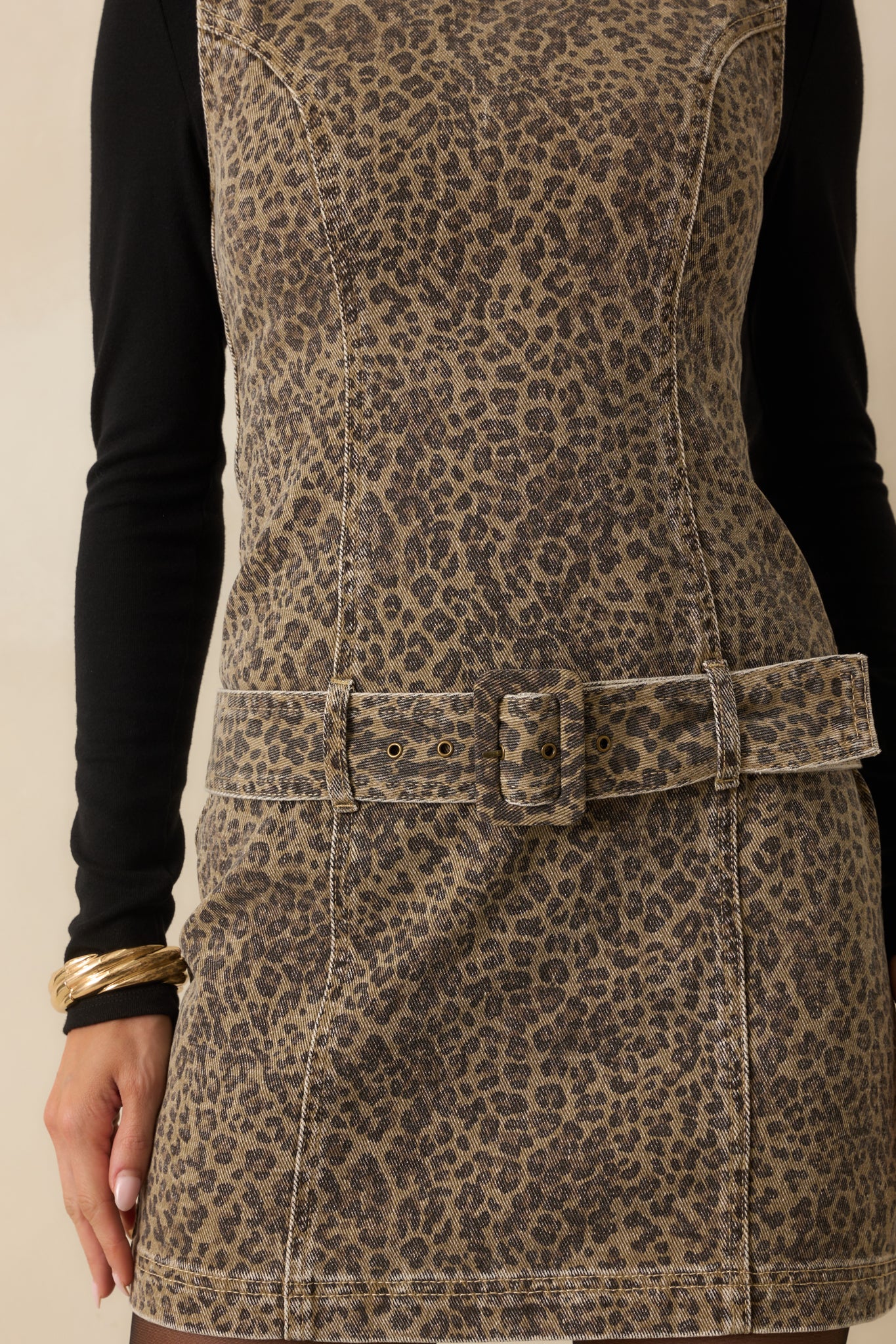 Washed brown leopard print denim fabric shown in close-up.