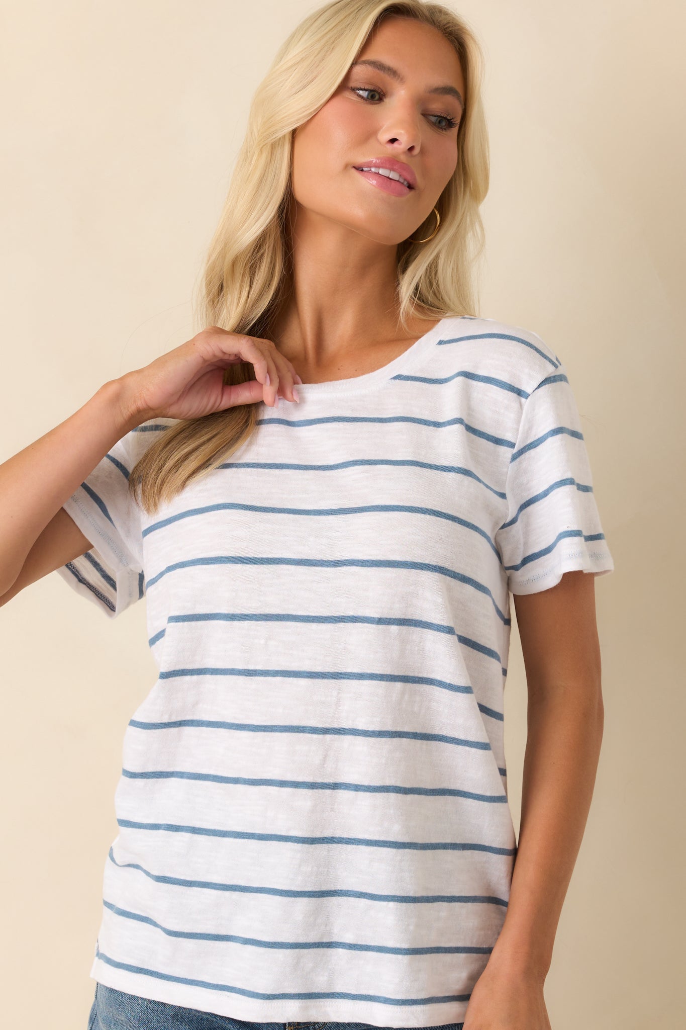 Cropped view of the neckline and shoulder area, focusing on the crew neck seam and fabric texture