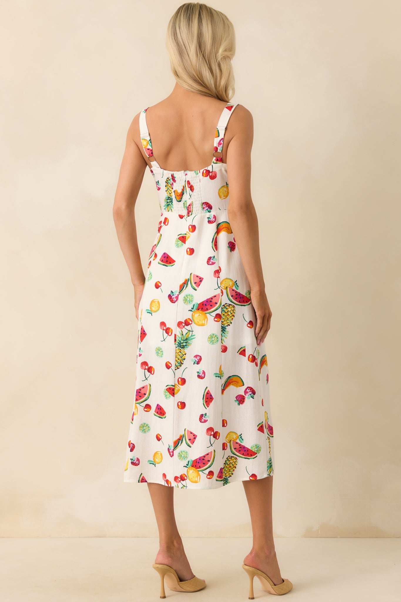 Rear view of the dress displaying the smocked back panel, adjustable straps, and hidden back zipper closure for a smooth finish.