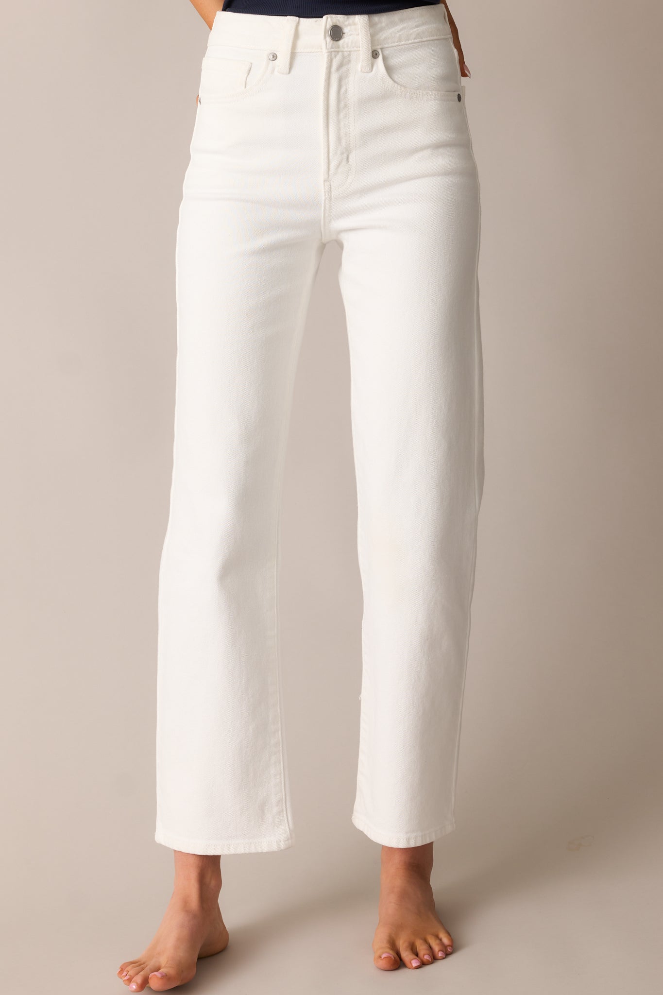 A detailed view of the jeans’ straight-leg cut, highlighting the smooth fabric and tailored structure