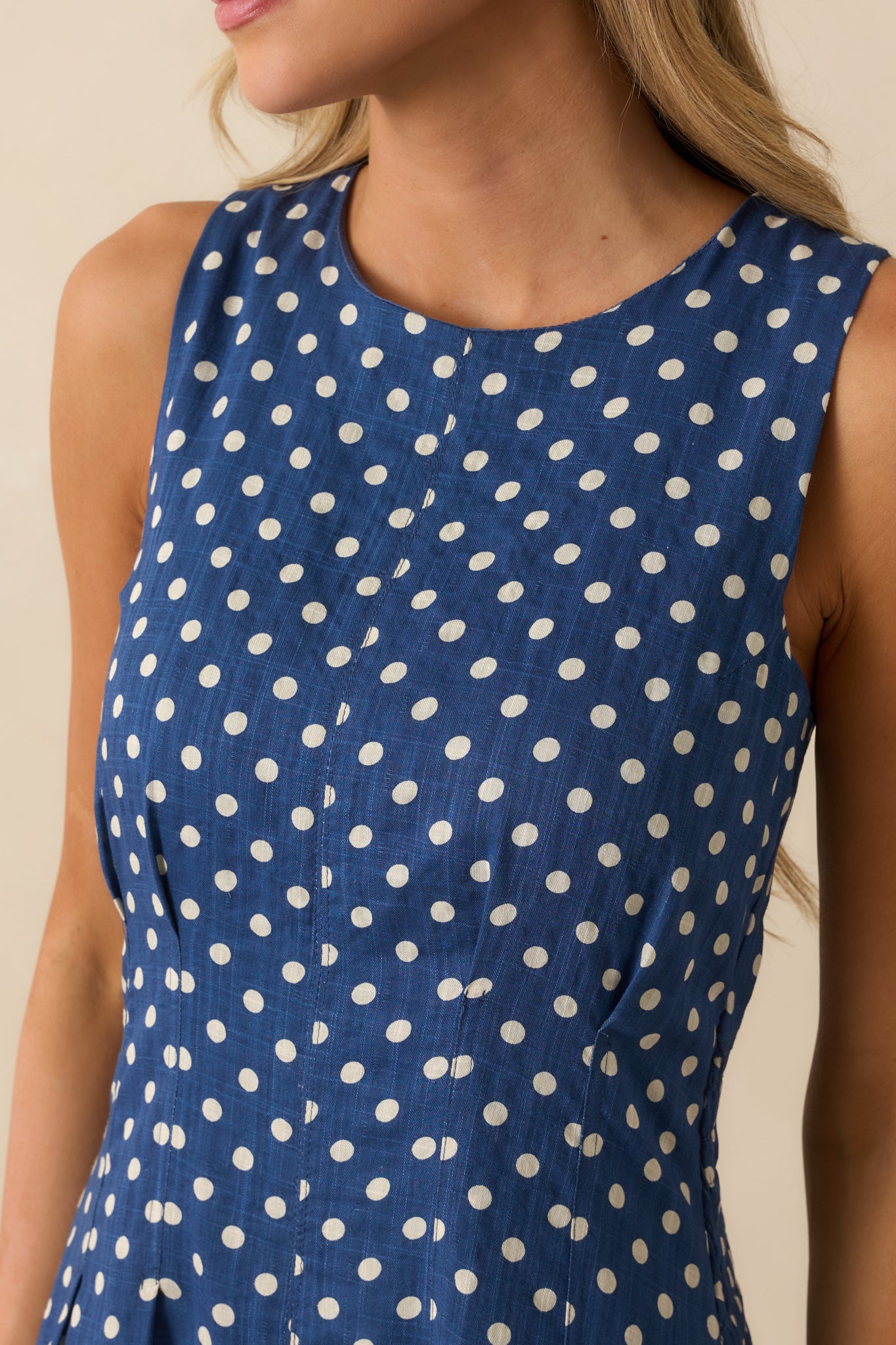 White polka dot pattern and bodice dart detailing shown on the navy fabric.