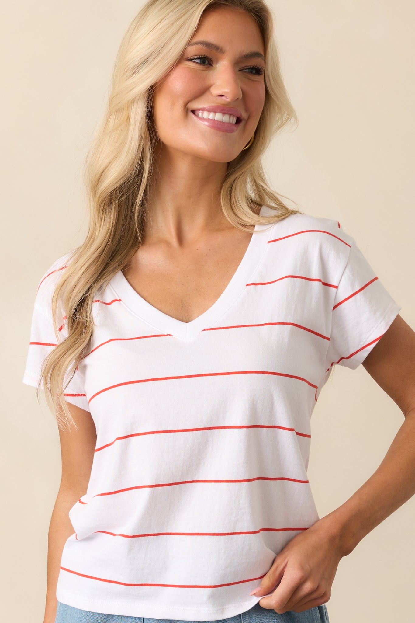 Red and white striped cotton tee with a V-neckline and short sleeves, shown in a relaxed, casual fit.