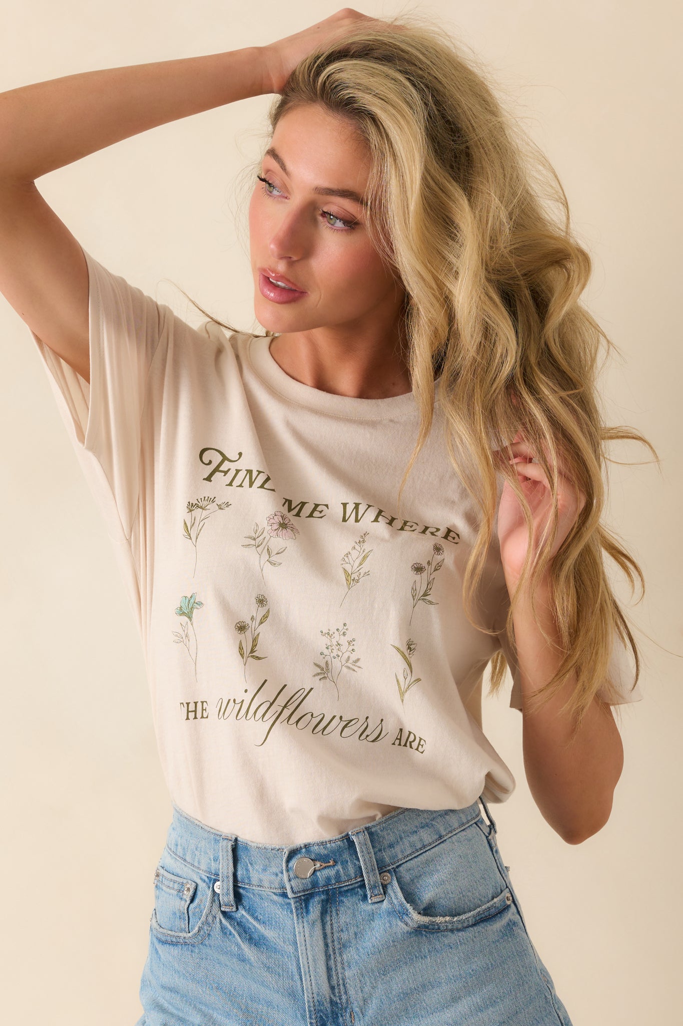 Front-facing full body photo highlighting the “Find Me Where The Wildflowers Are” graphic and short sleeve design.