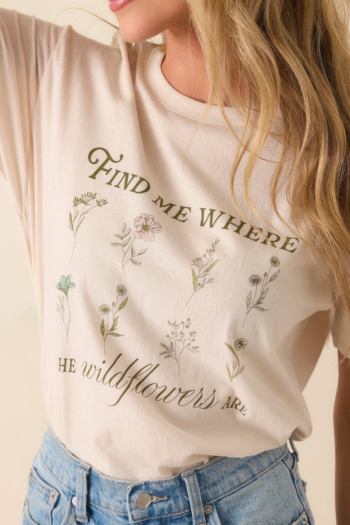 Close-up of the graphic print showing the phrase “Find Me Where The Wildflowers Are” surrounded by detailed floral artwork.