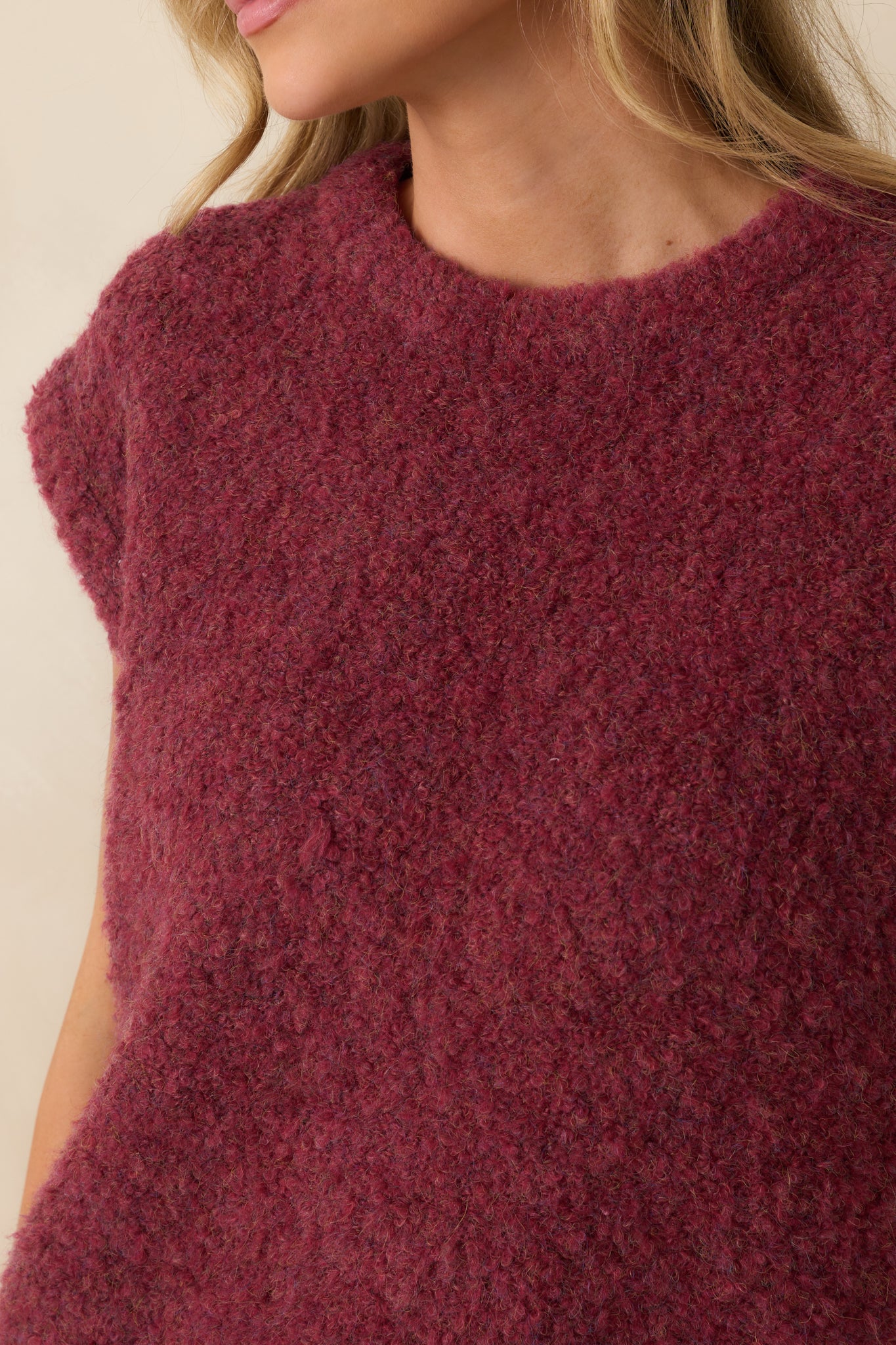 Fabric close-up displaying the soft knit texture and deep wine color of the sweater vest.
