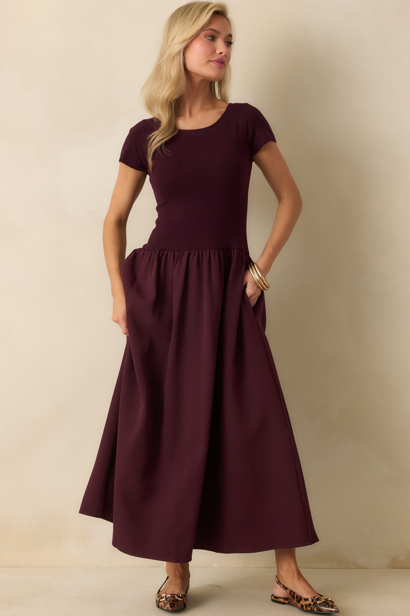 Maxi dress in a rich wine shade, styled with short sleeves, a gathered skirt, and a straight hemline.