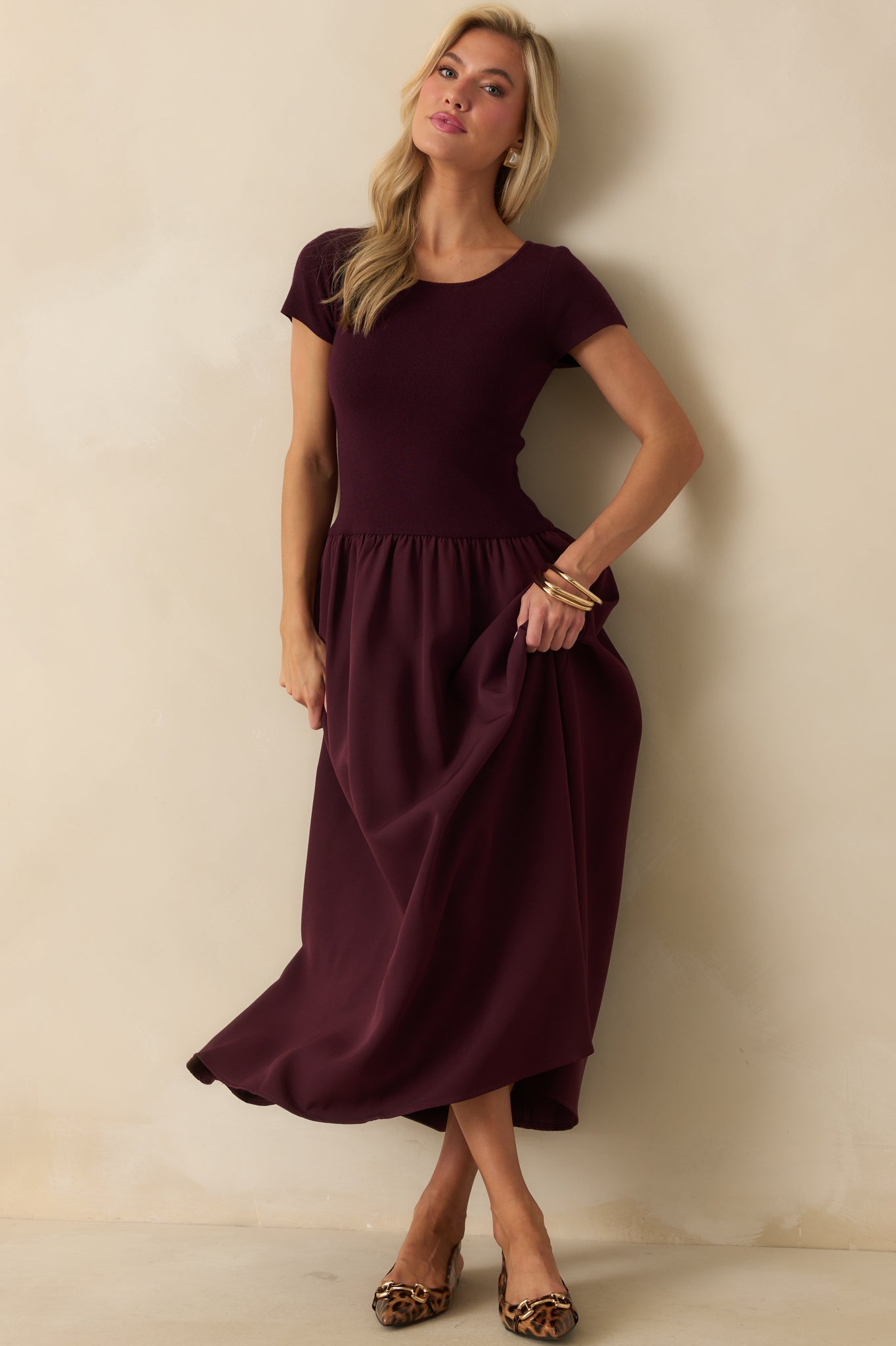 Wine red maxi dress with a ribbed knit bodice, scoop neckline, and a flowing A-line skirt.