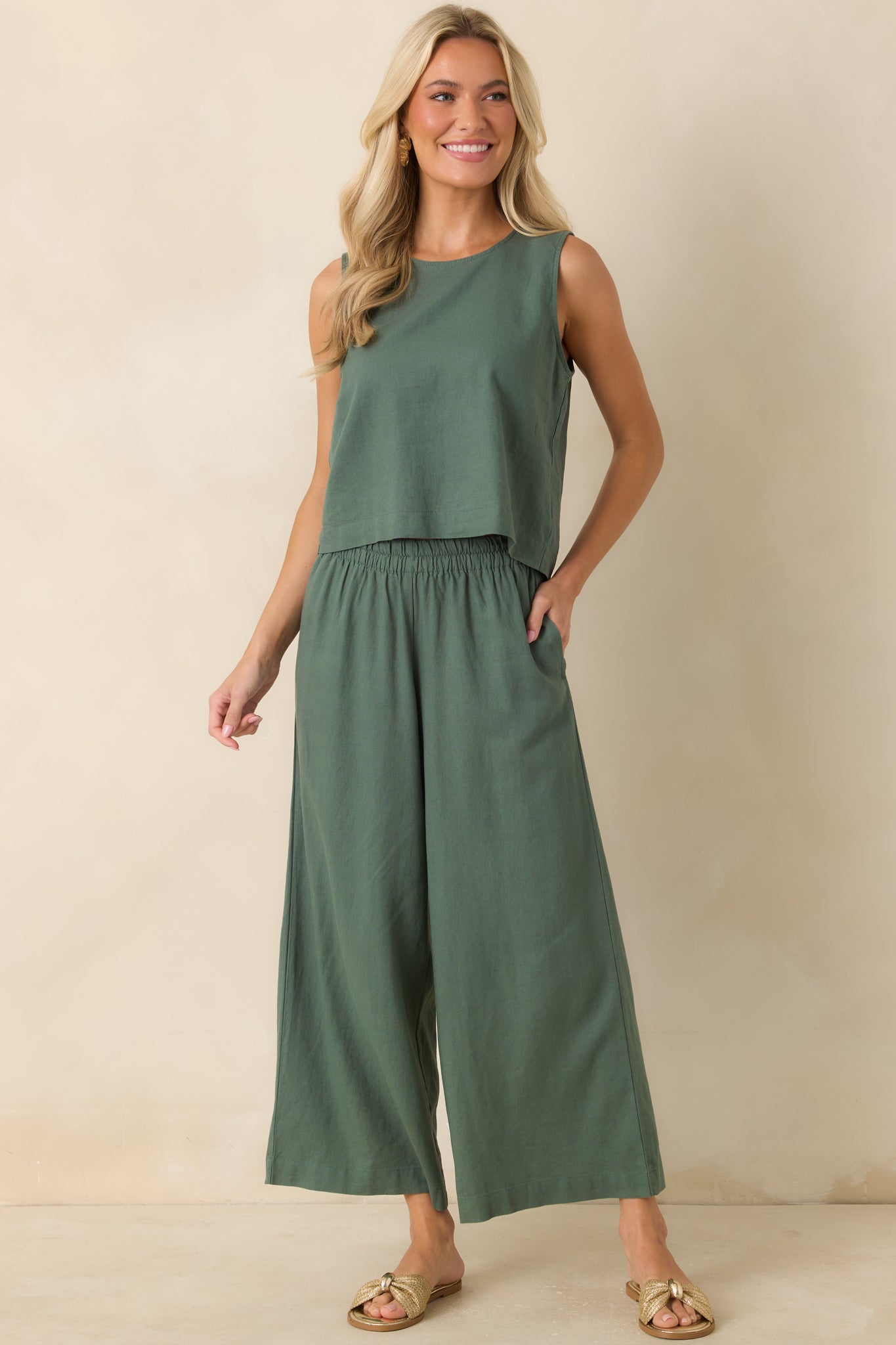 Everglade green linen blend top featuring a relaxed boxy silhouette, crew neckline, and slightly cropped length.