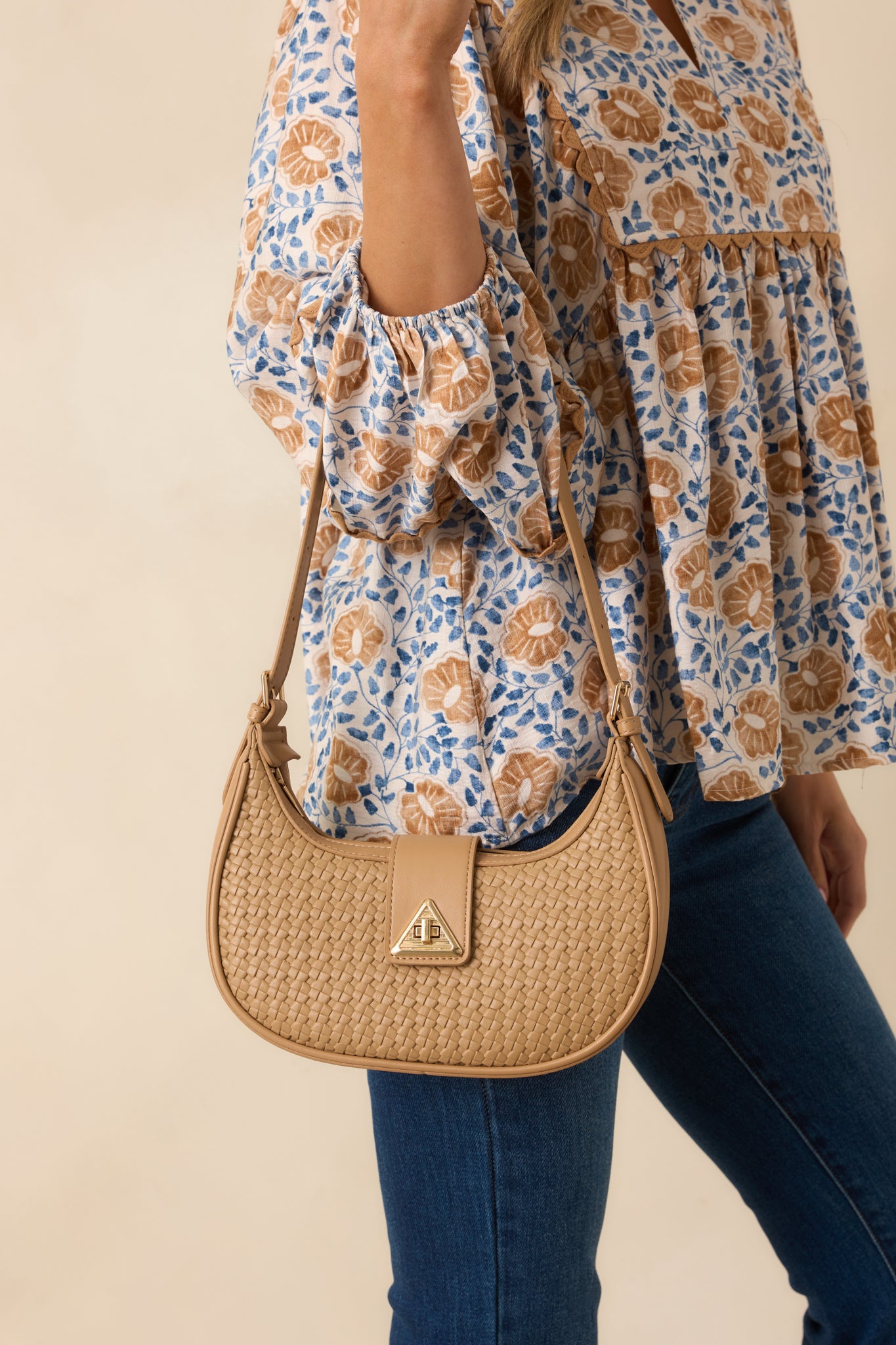 Cropped shot capturing the woven faux leather texture and the rounded curve of the half-moon silhouette.