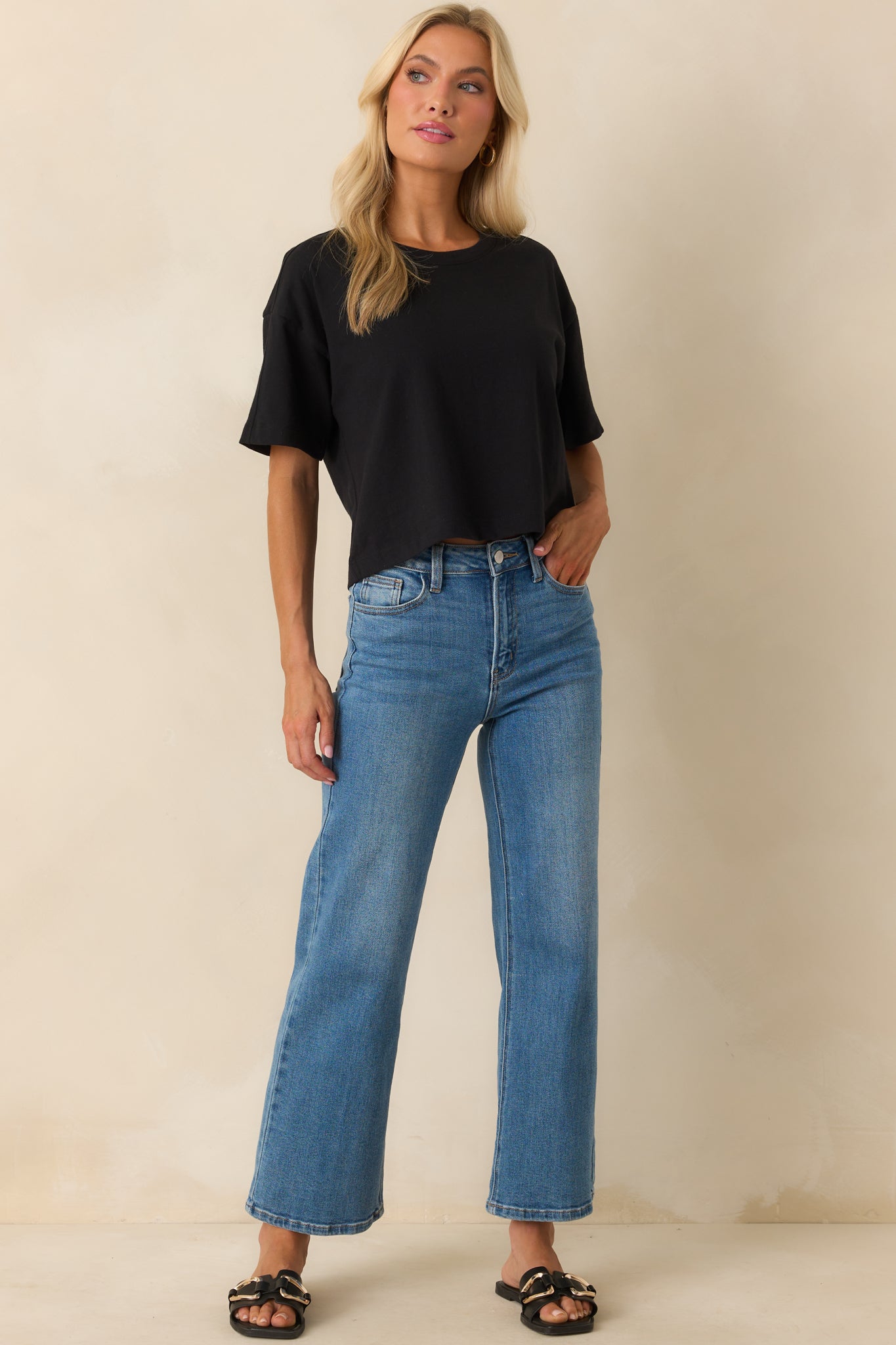 Full front view showing the crew neckline, lightweight fabric, and straight hemline of the black tee.