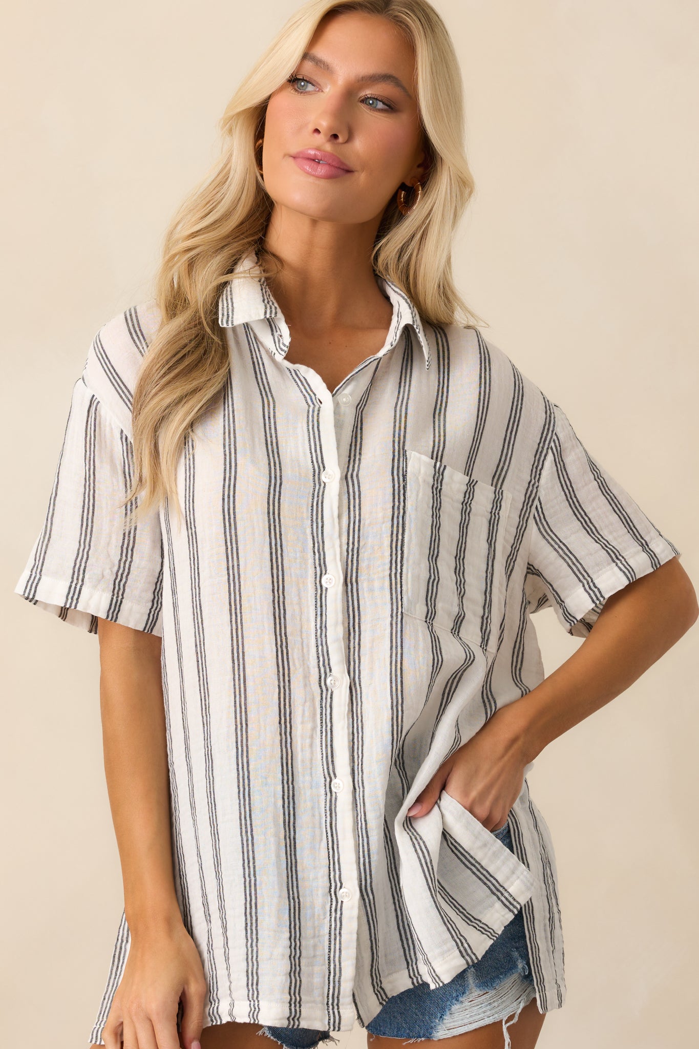 Mid-frame shot emphasizing the functional buttons and vertical stripe pattern of the cotton gauze top.