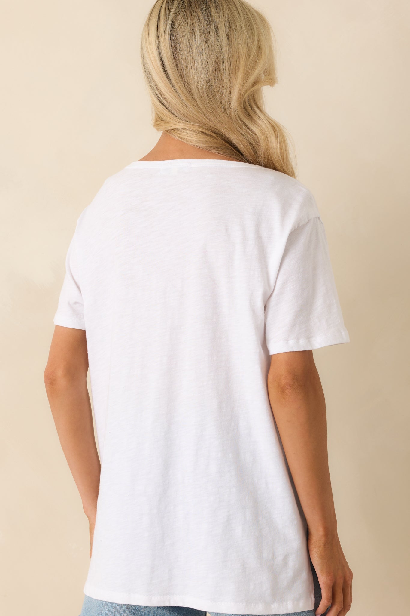 A back view of the tee showing the straight hem, short sleeves, and relaxed overall fit.
