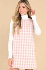 Front view of this dress that showcases the plaid pattern in shades of pink.