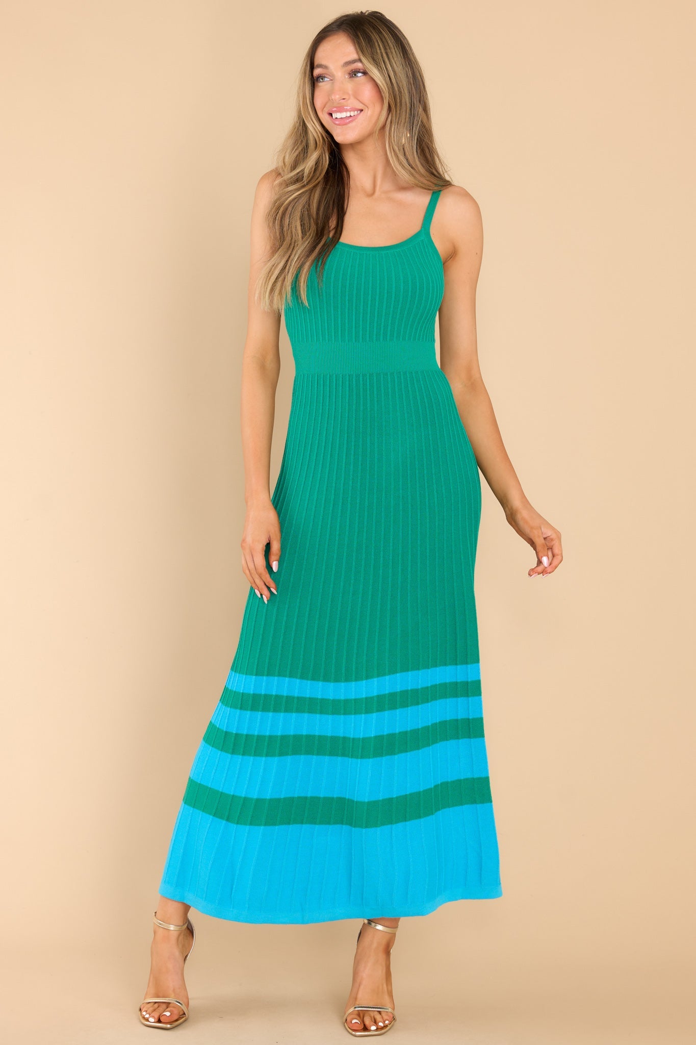 Full body view of this dress that features a scoop neckline, non-adjustable straps, a ribbed texture, and stretch throughout.