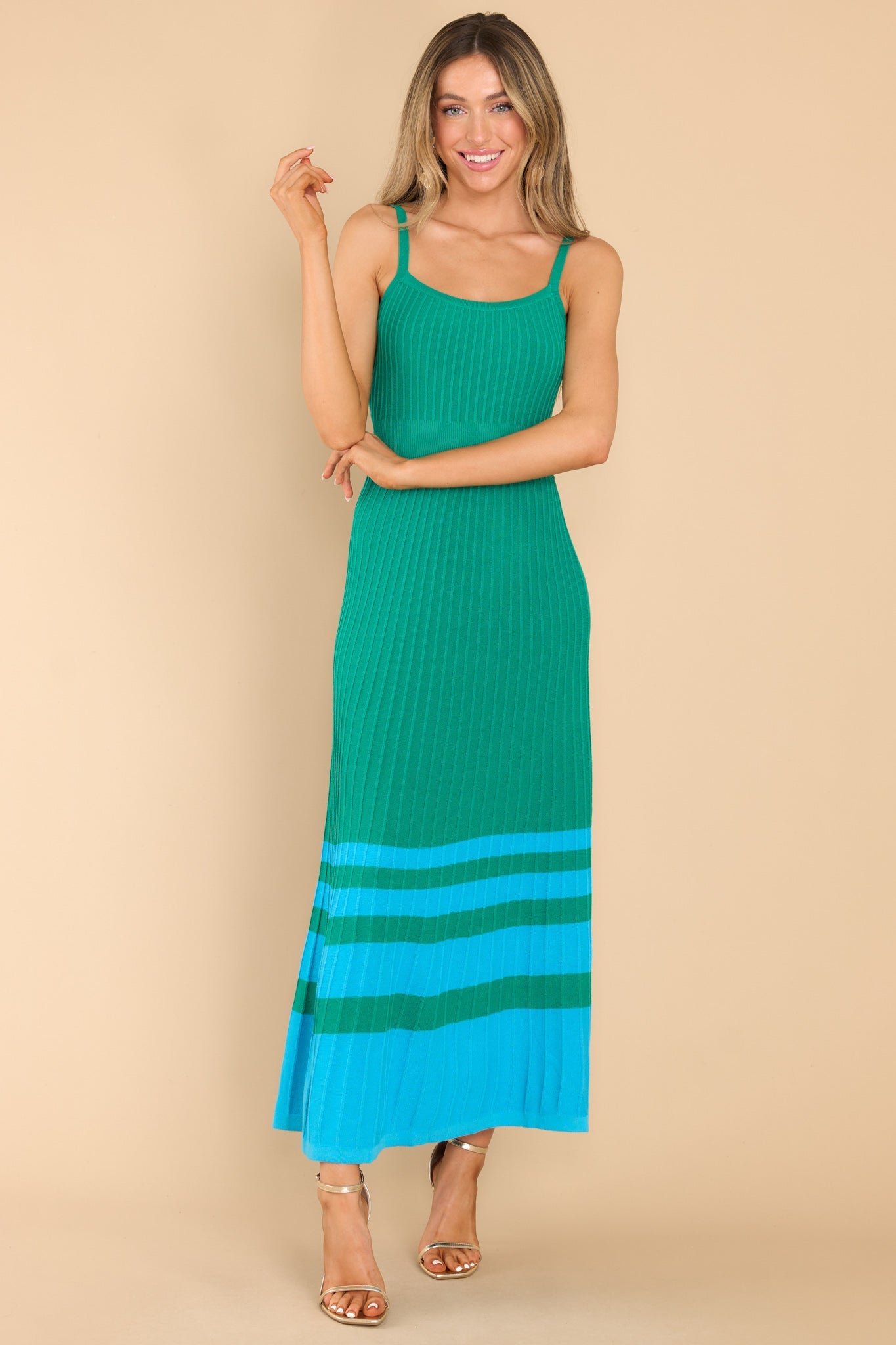 This green and blue dress features a scoop neckline, non-adjustable straps, a ribbed texture, and stretch throughout.