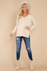 Full body view of this sweater that features a seam down the center front and high-low hem with side slits.
