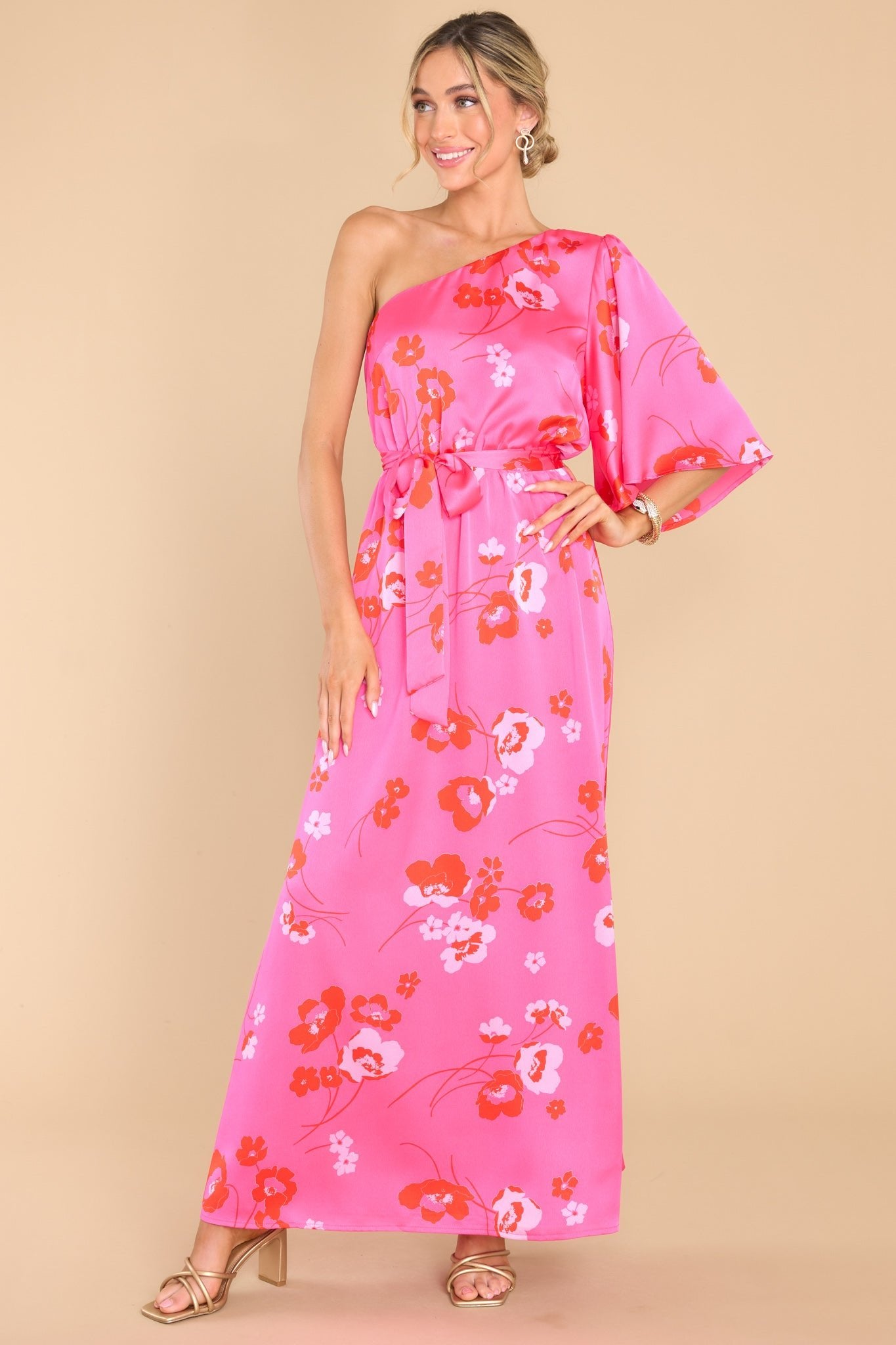 Full body view of this dress that features an asymmetrical one shoulder neckline, one butterfly sleeve, and an elastic waistband with a self-tie belt.