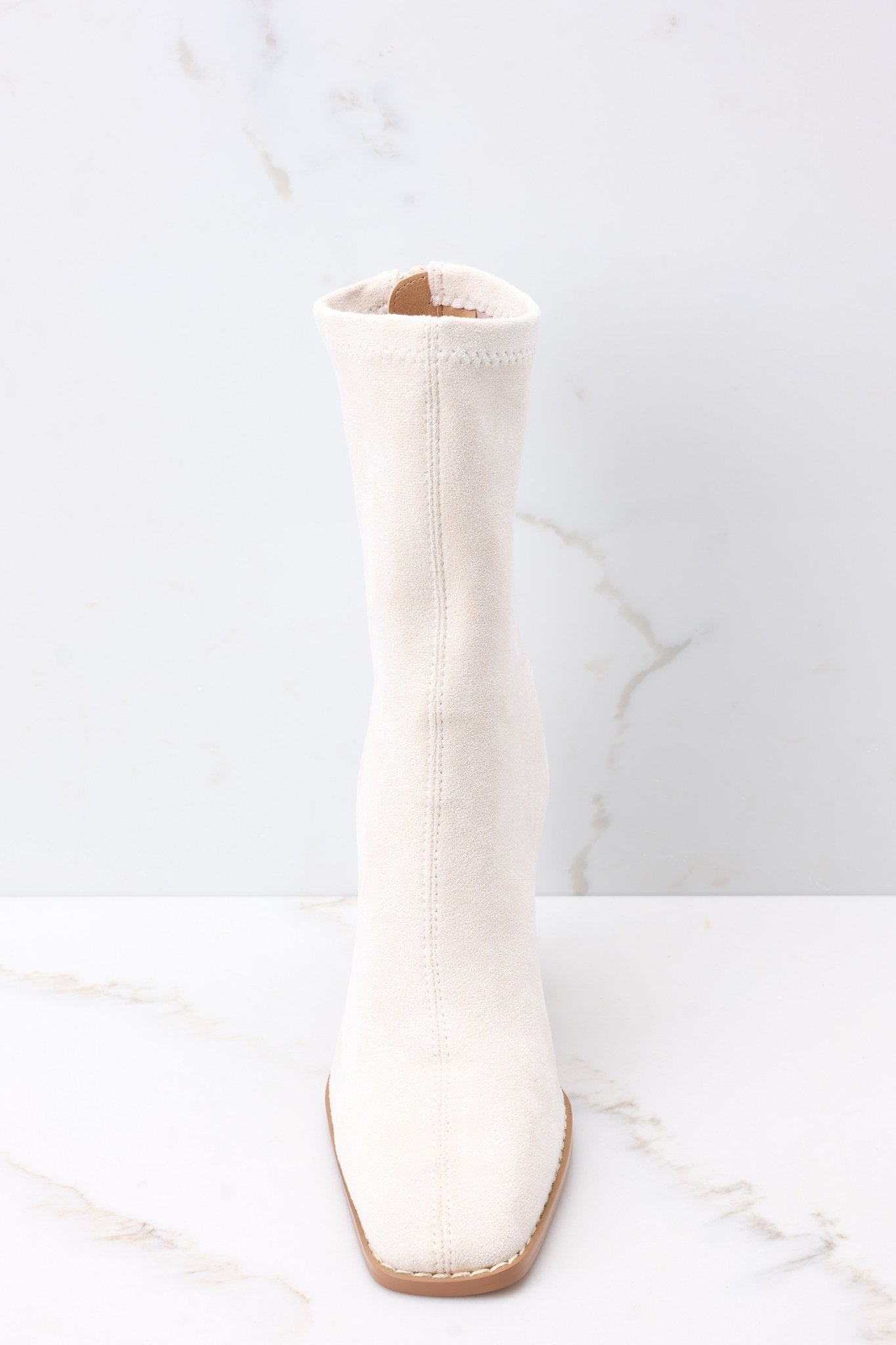 Front view of ivory high heel booties with a soft suede texture throughout.
