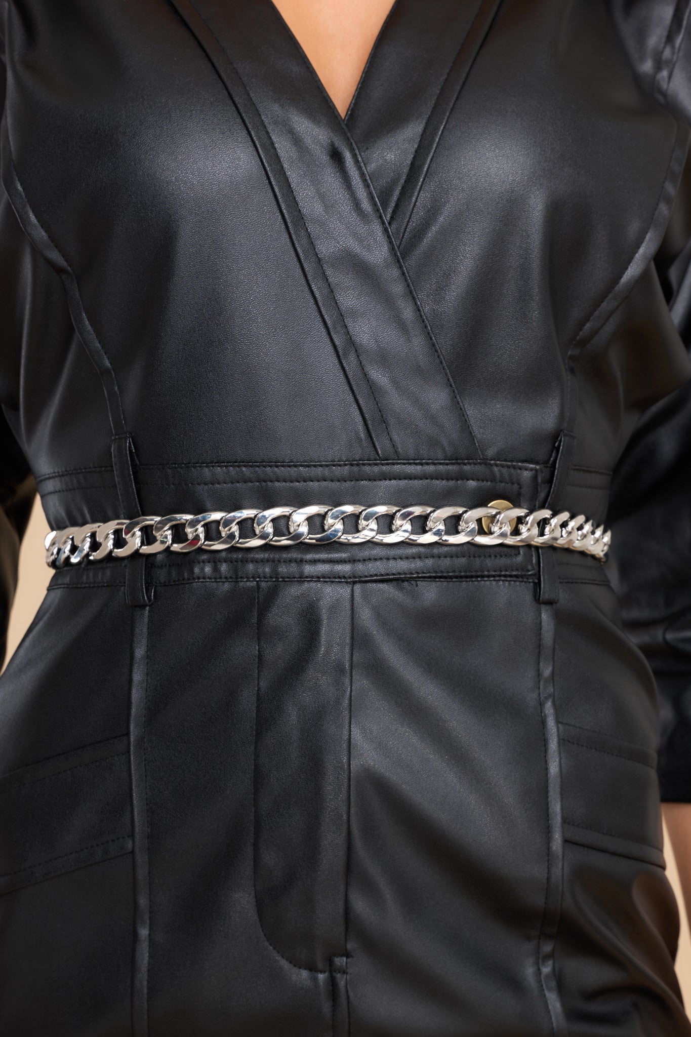 This silver belt features a chain link design with a hook closure.