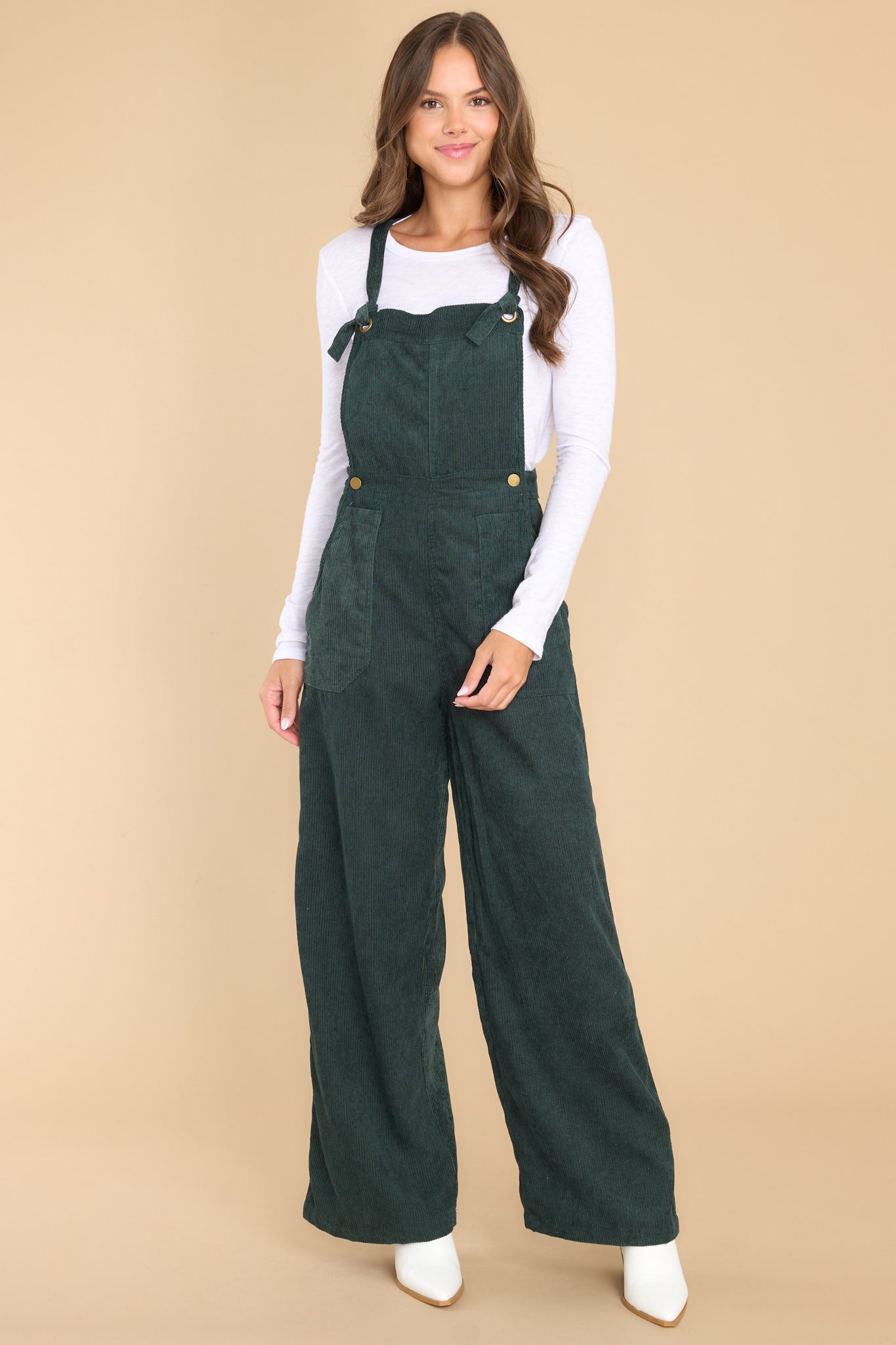 Full body view of these overalls that feature a corduroy texture throughout.