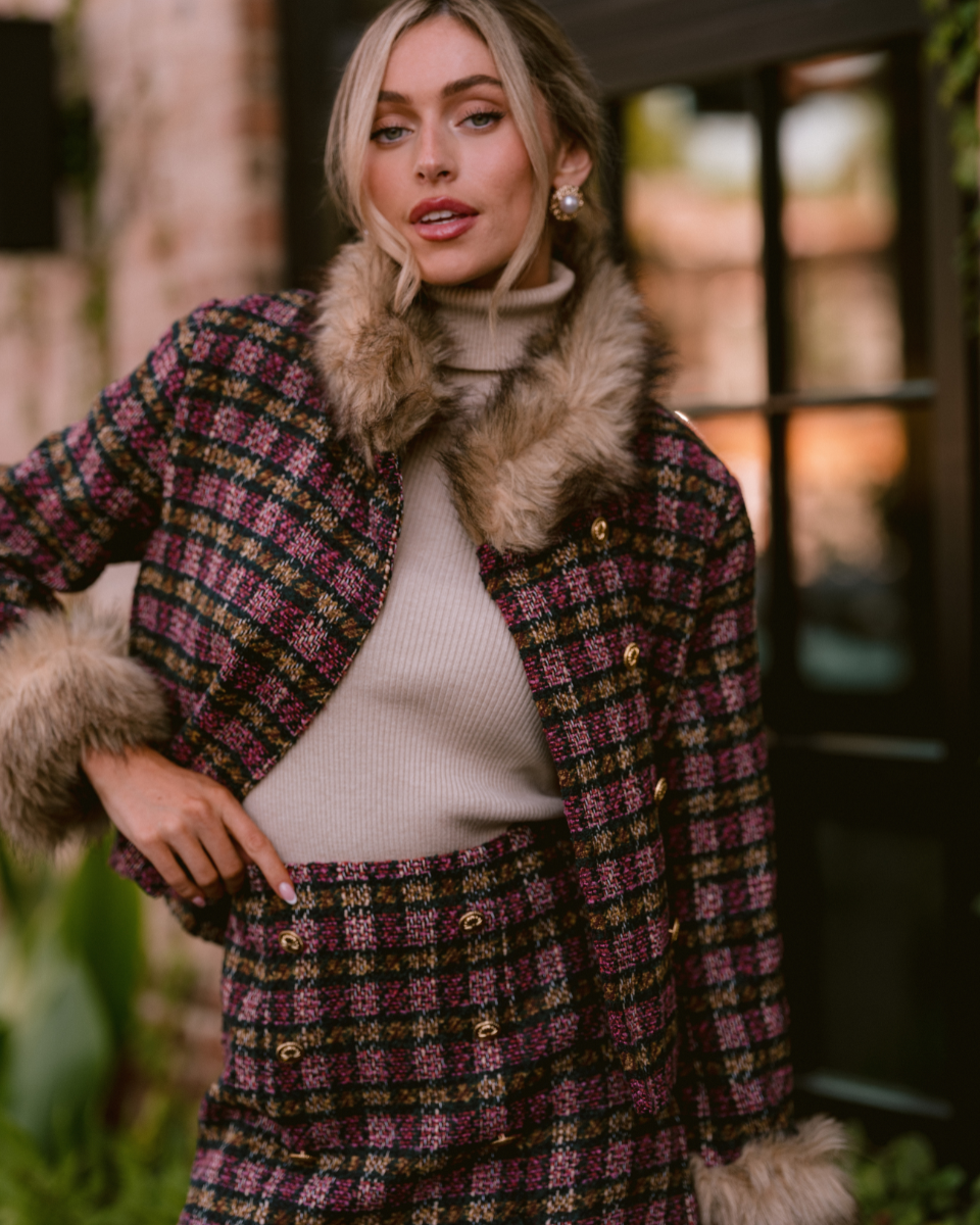 Image of model wearing a Pink Multi Plaid Tweed Jacket with a matching mini skirt.