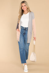 This grey multi-colored cardigan features color blocking and functional pockets.