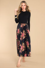 Front view of this dress that features a crew neckline, a ribbed sweater bodice and a pleated, floral satin like skirt.