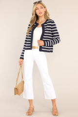 Full body view of this cardigan that features a round ribbed neckline, long sleeves with ribbed cuffs, ribbed hemline, and a modern horizontal striped pattern.