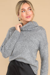 This grey sweater features a high chunky turtle neck, ribbed detailing on the cuffs and bottom hem, and a super soft fabric. 