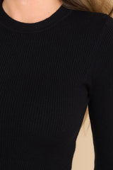 Close up of this dress that features a crew neckline and a black ribbed sweater bodice.